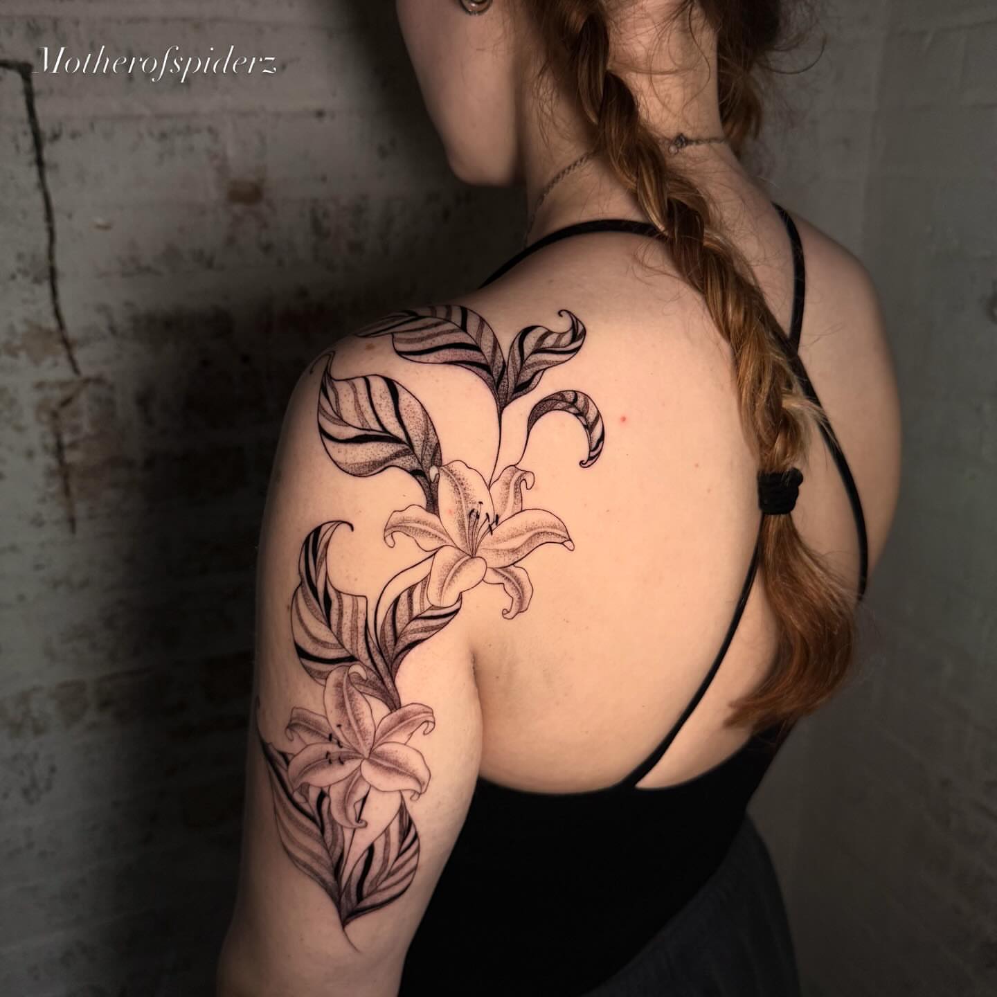 Lily black and grey tattoo on the shoulder by Alyssa Garza