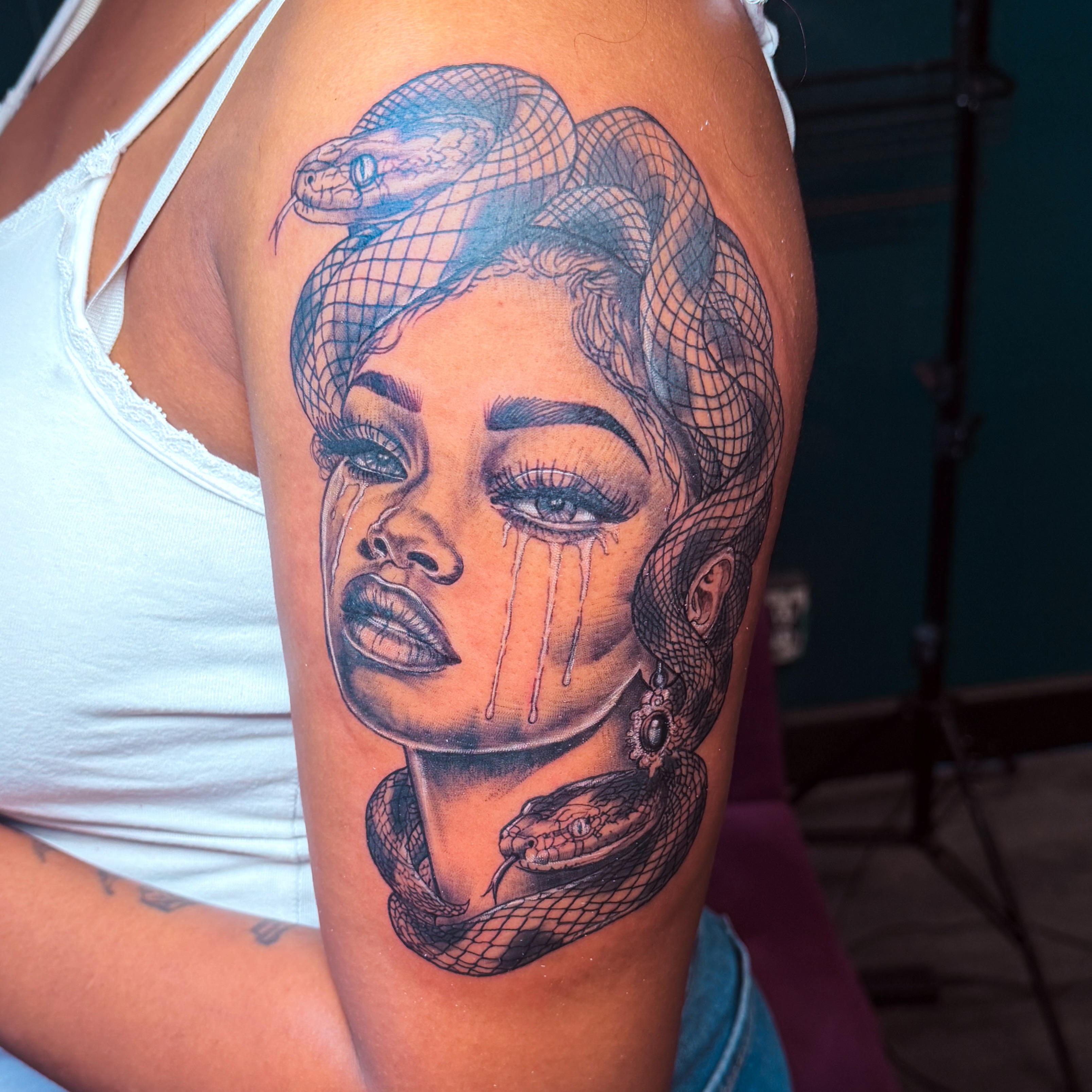Woman with snake realism tattoo on the shoulder by Emac, Baltimore, Maryland