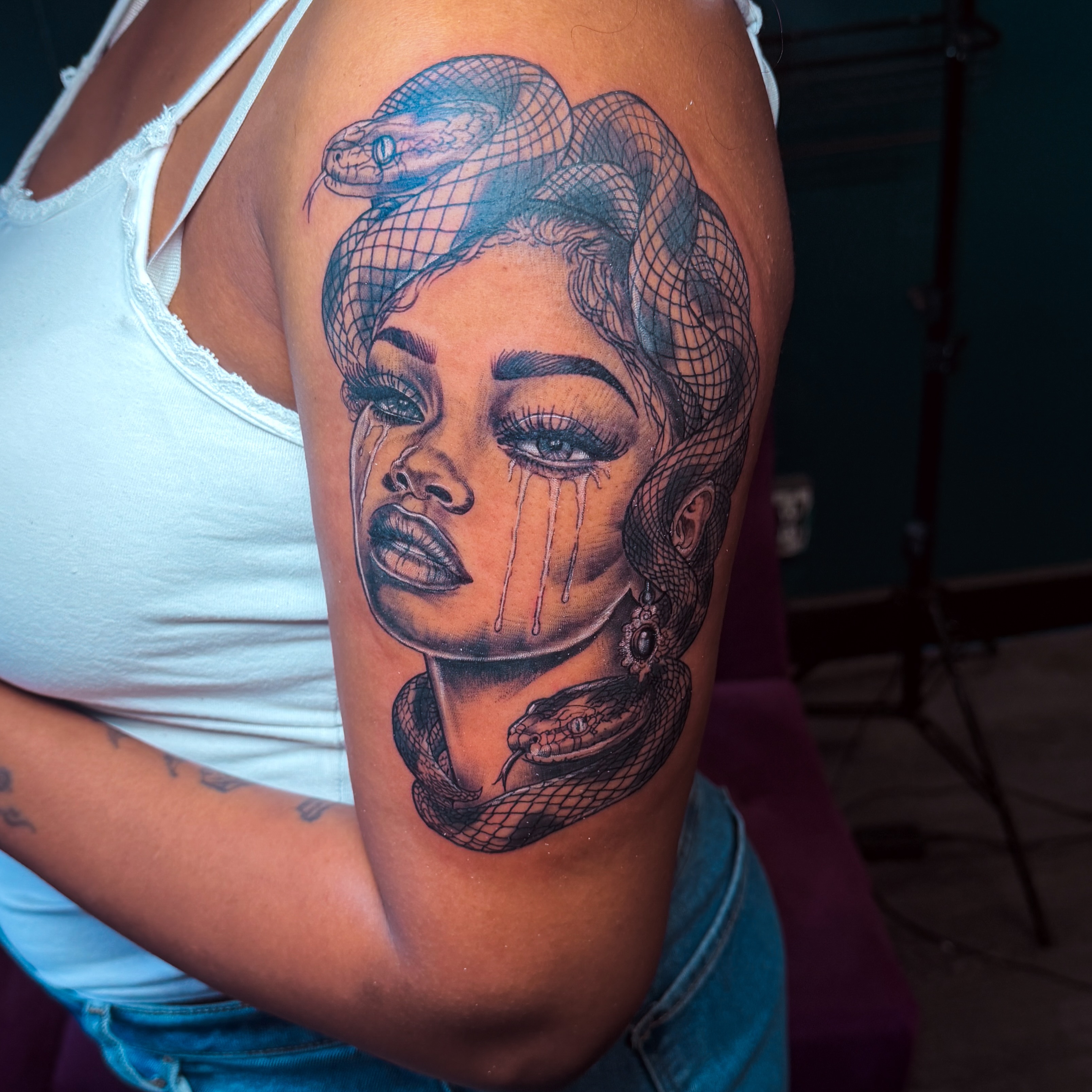 Woman with snakes realism tattoo on the upper arm by Emac, Baltimore, Maryland