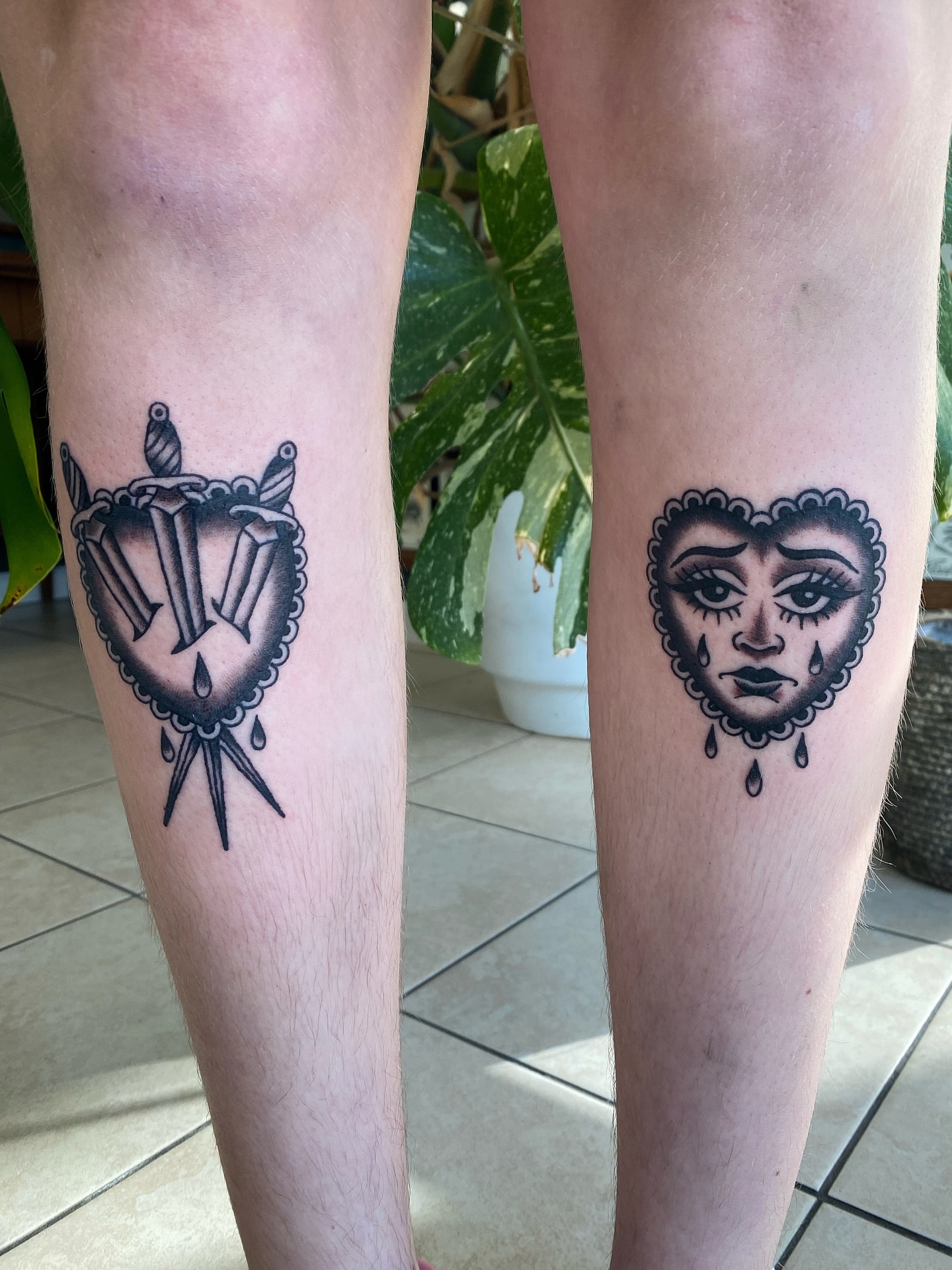 Mask black and grey tattoo on the leg by Corinne Carter