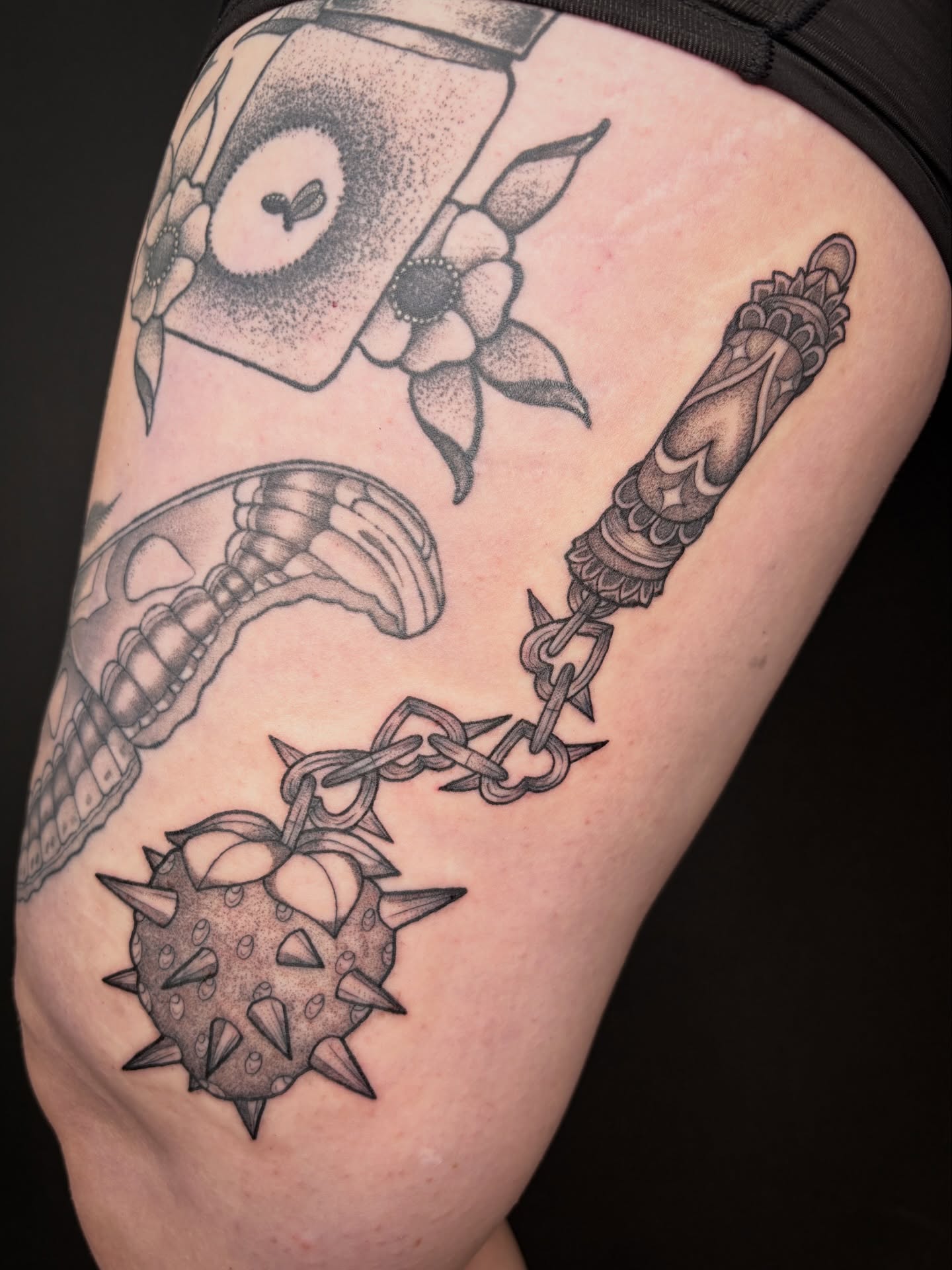 Spiked ball and chain dotwork tattoo on the thigh by Poppy Olivia Deards