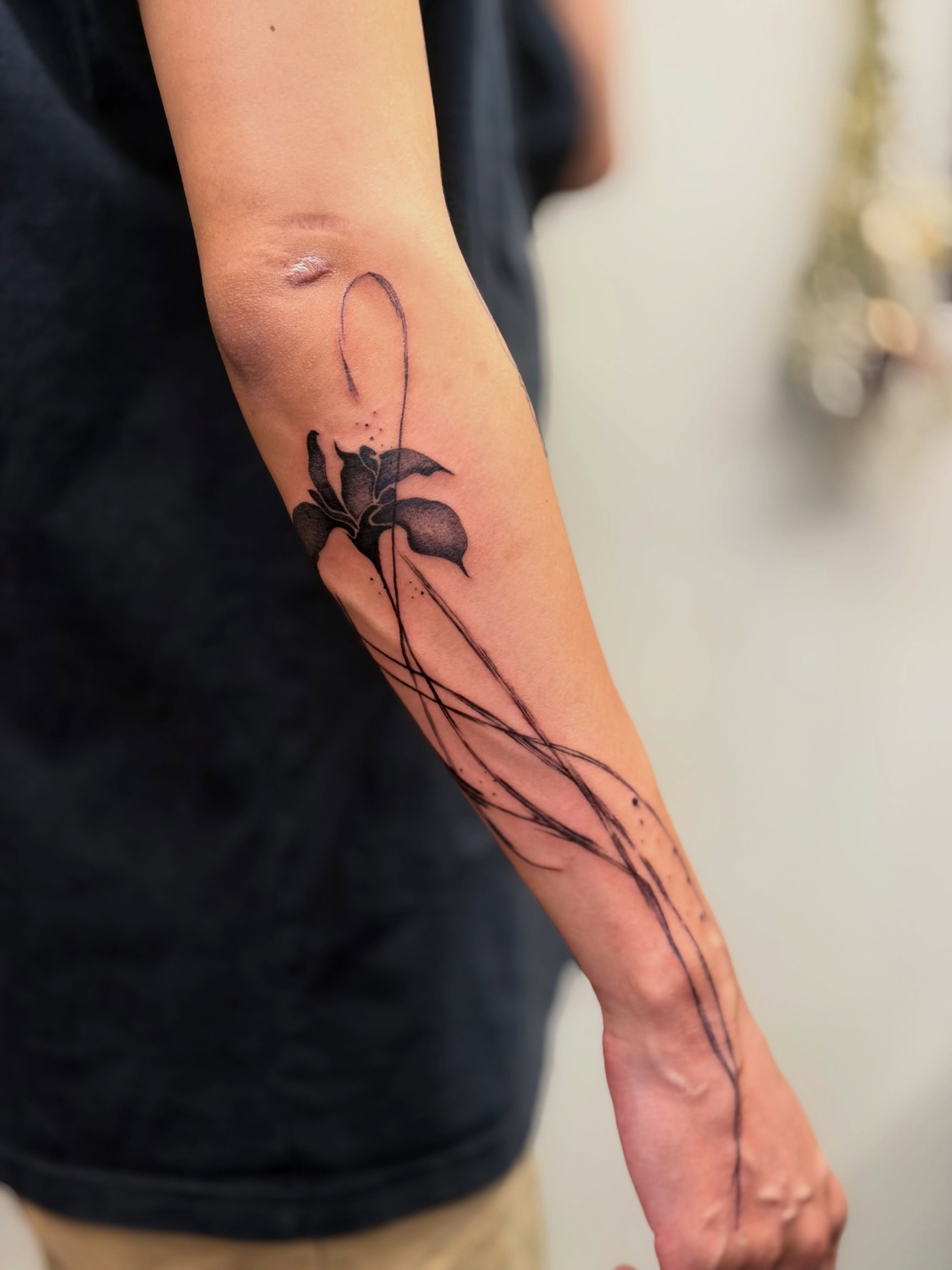 Flower dotwork tattoo on the forearm by Bryan Nguyen