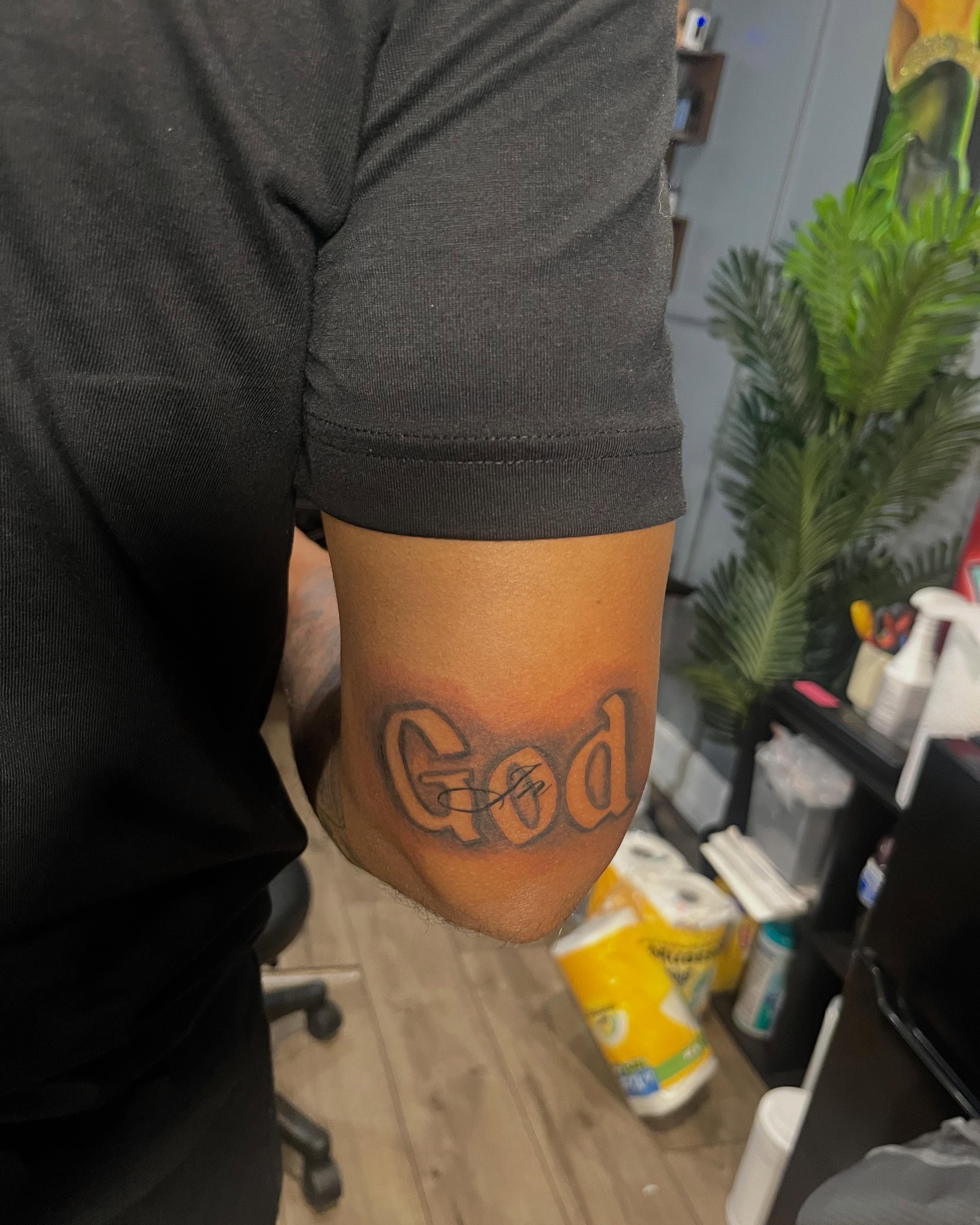 God lettering script tattoo on the forearm by SpicyMvstardInkk