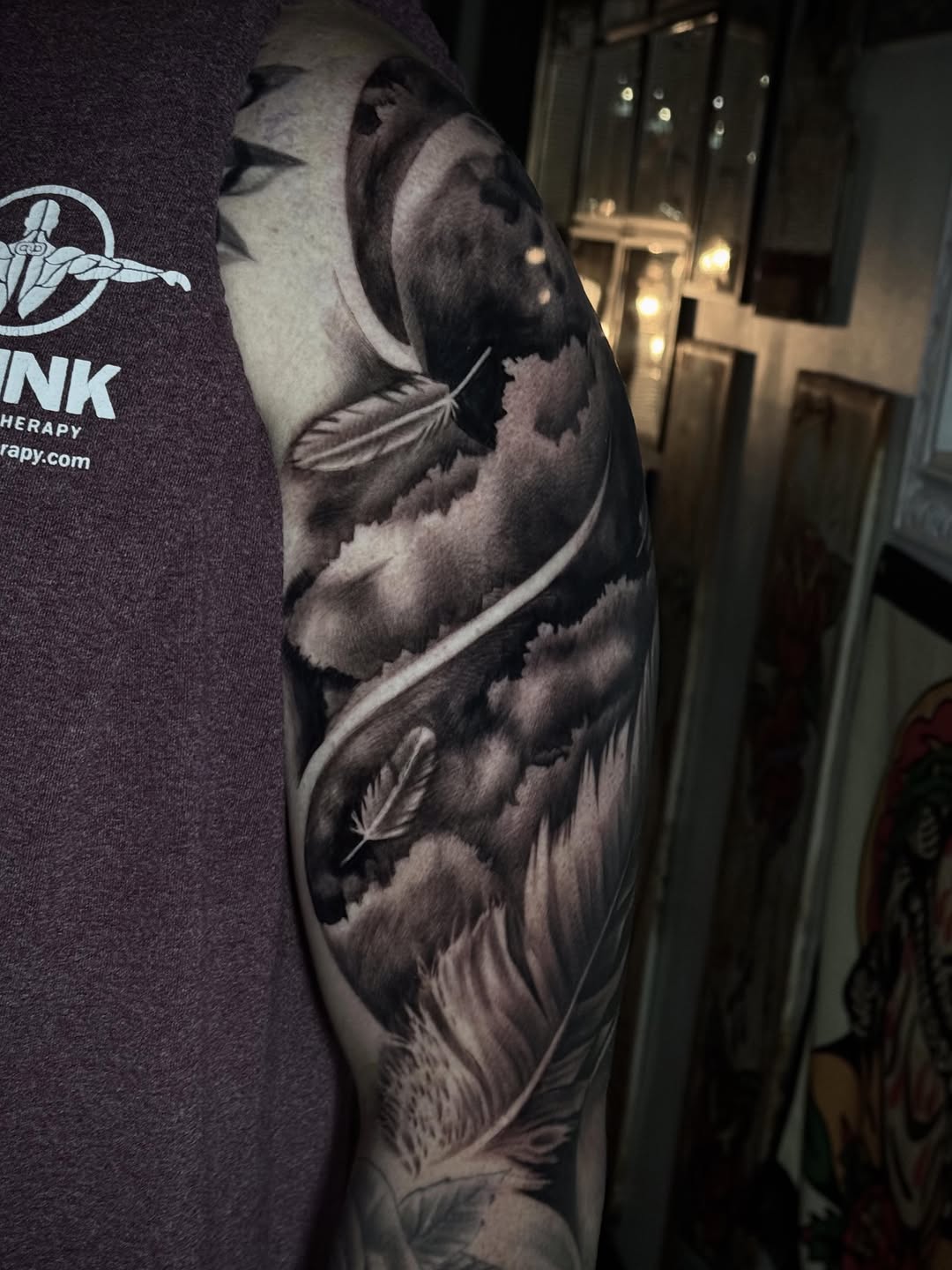 Feathers and clouds realism tattoo on the forearm by Tony Garcia