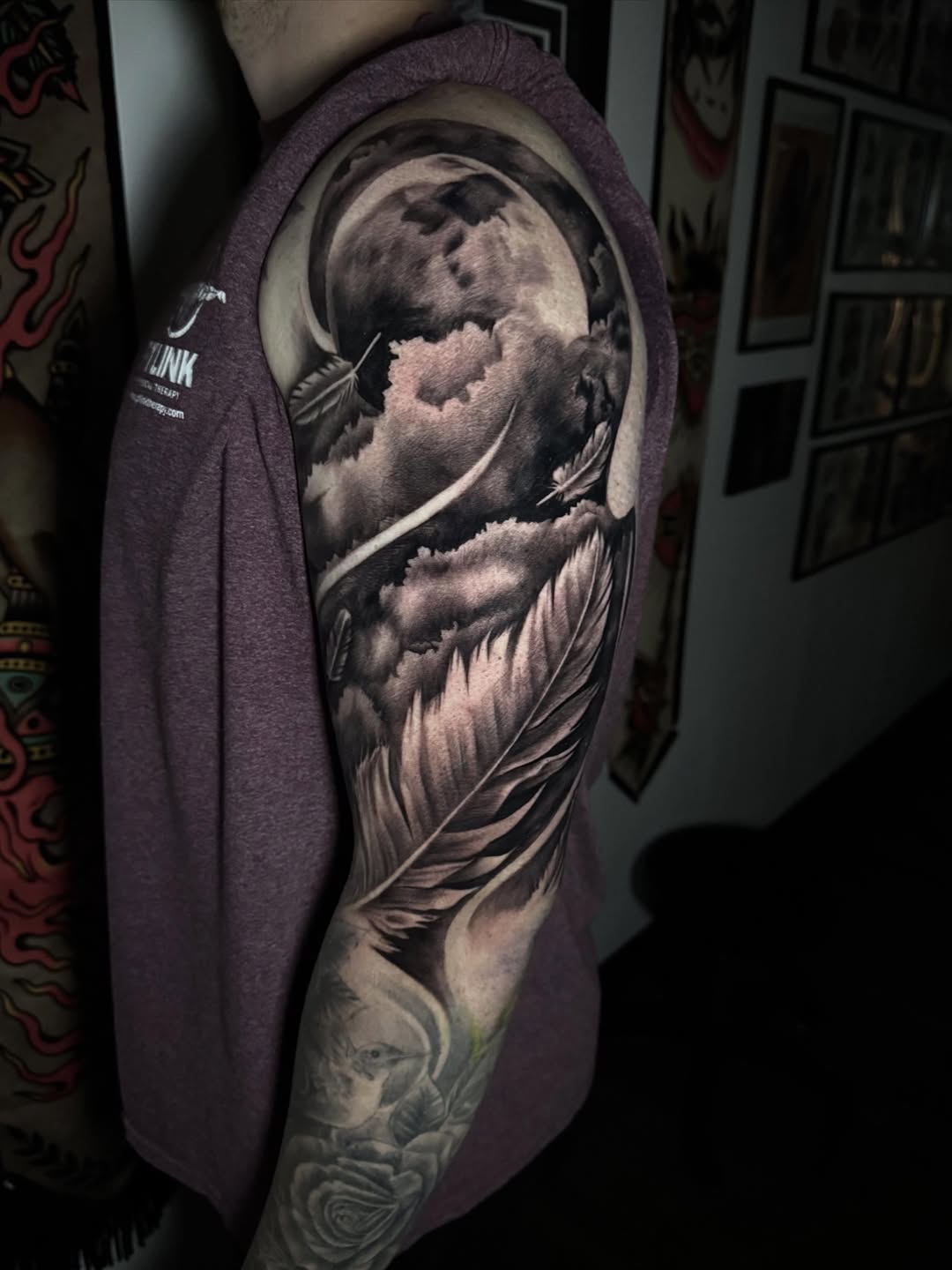 Moon and feather realism tattoo on the upper arm by Tony Garcia