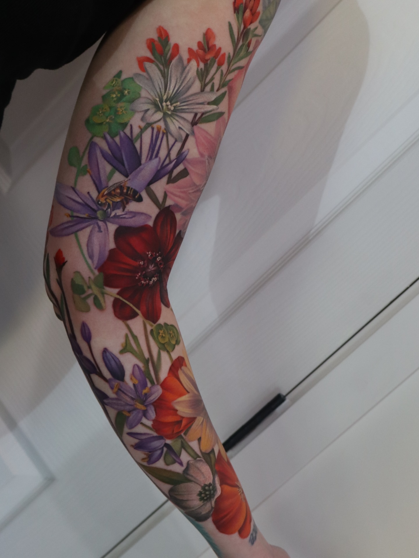 Floral bouquet realism tattoo on the forearm by Anali De Laney
