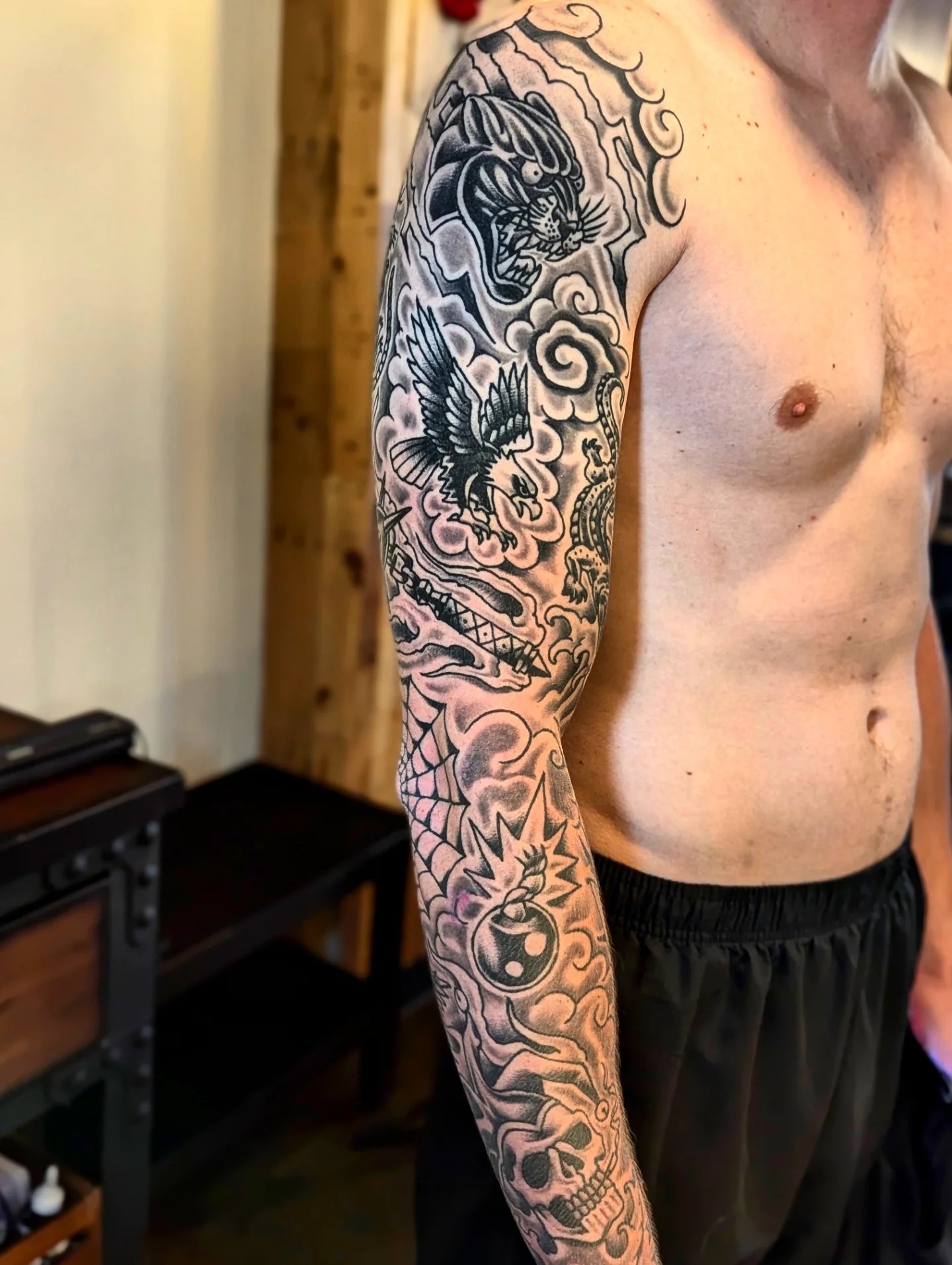 Dragon and eagle American traditional tattoo on the upper arm by Eric Ward