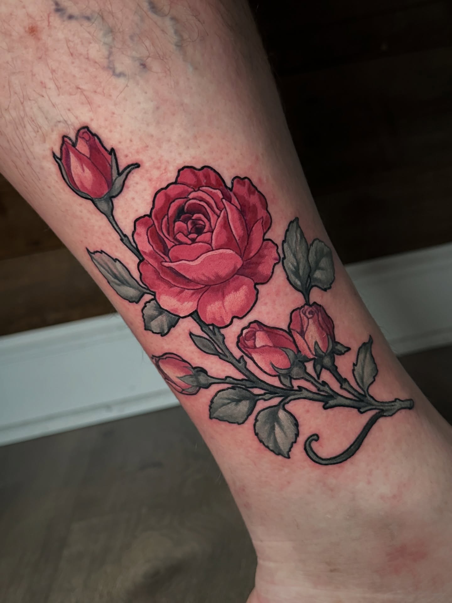 Roses American traditional tattoo on the forearm by Joe Friedman