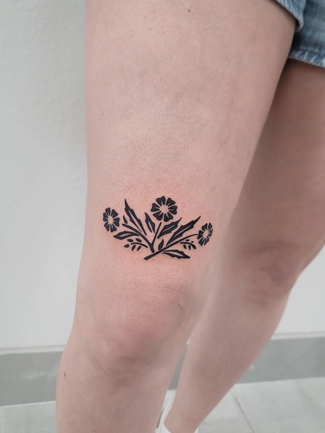 Floral arrangement ornamental tattoo on the thigh by Las Vegas Fine Line Tattoos