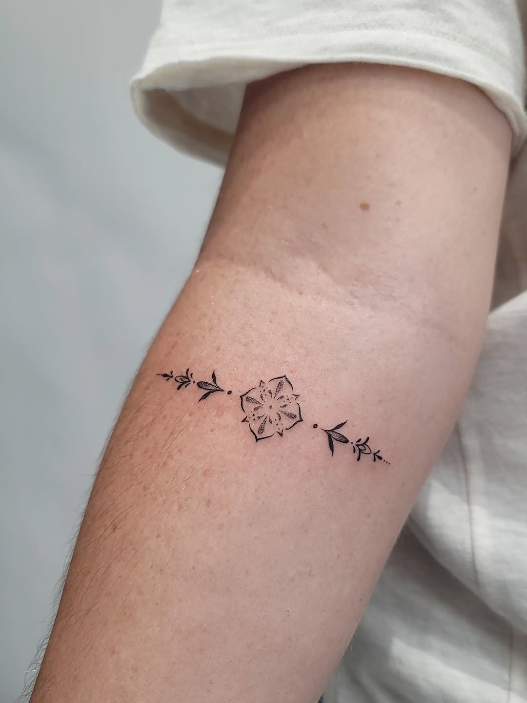 Ornamental floral band ornamental tattoo on the forearm by Las Vegas Fine Line Tattoos