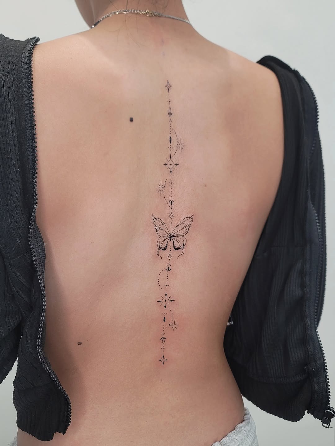 Butterfly and celestial elements ornamental tattoo on the back by Las Vegas Fine Line Tattoos