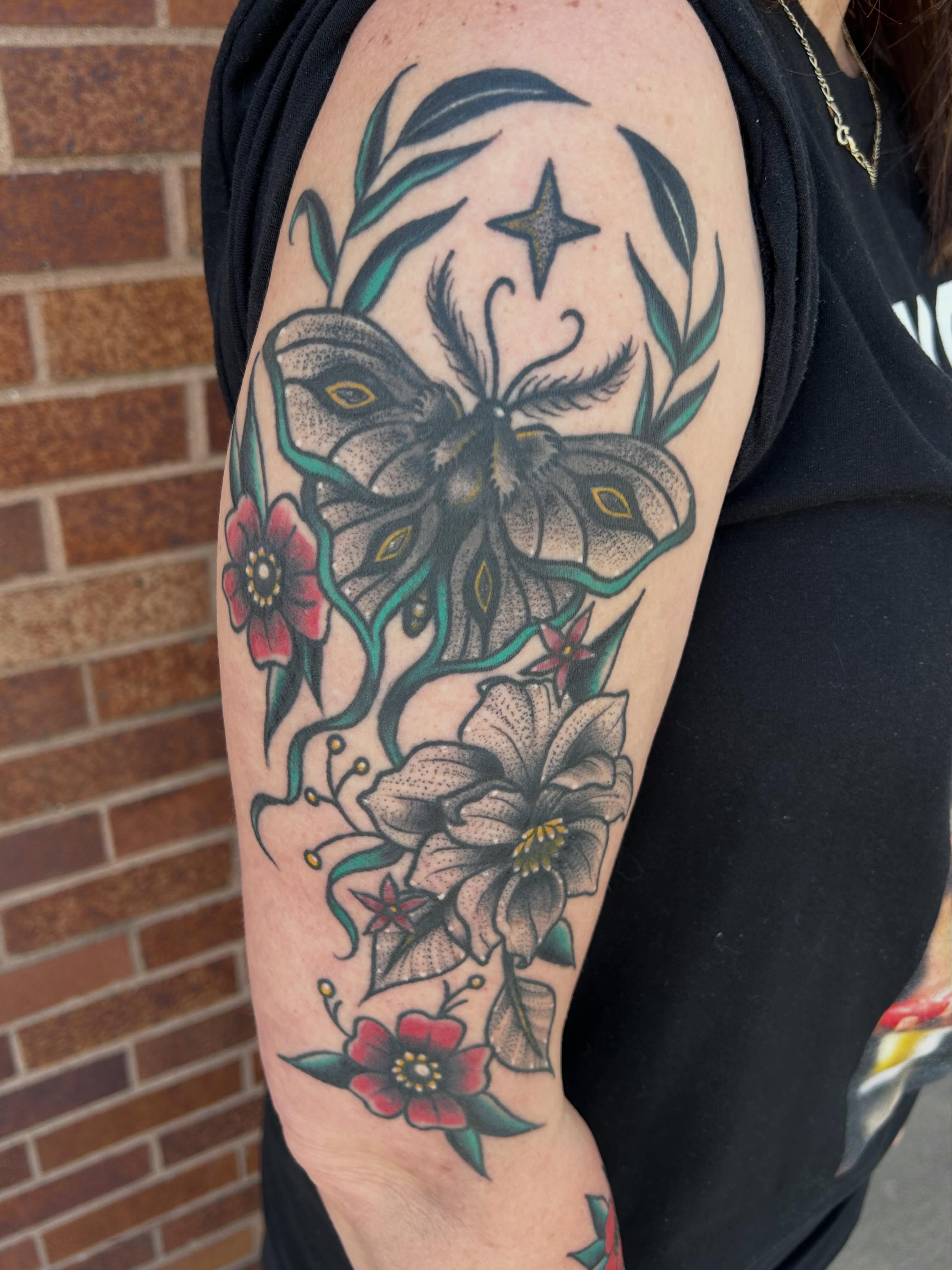 Butterfly and flowers American traditional tattoo on the forearm by Morgan Hazer Tattoos, Cedar Rapids, Iowa