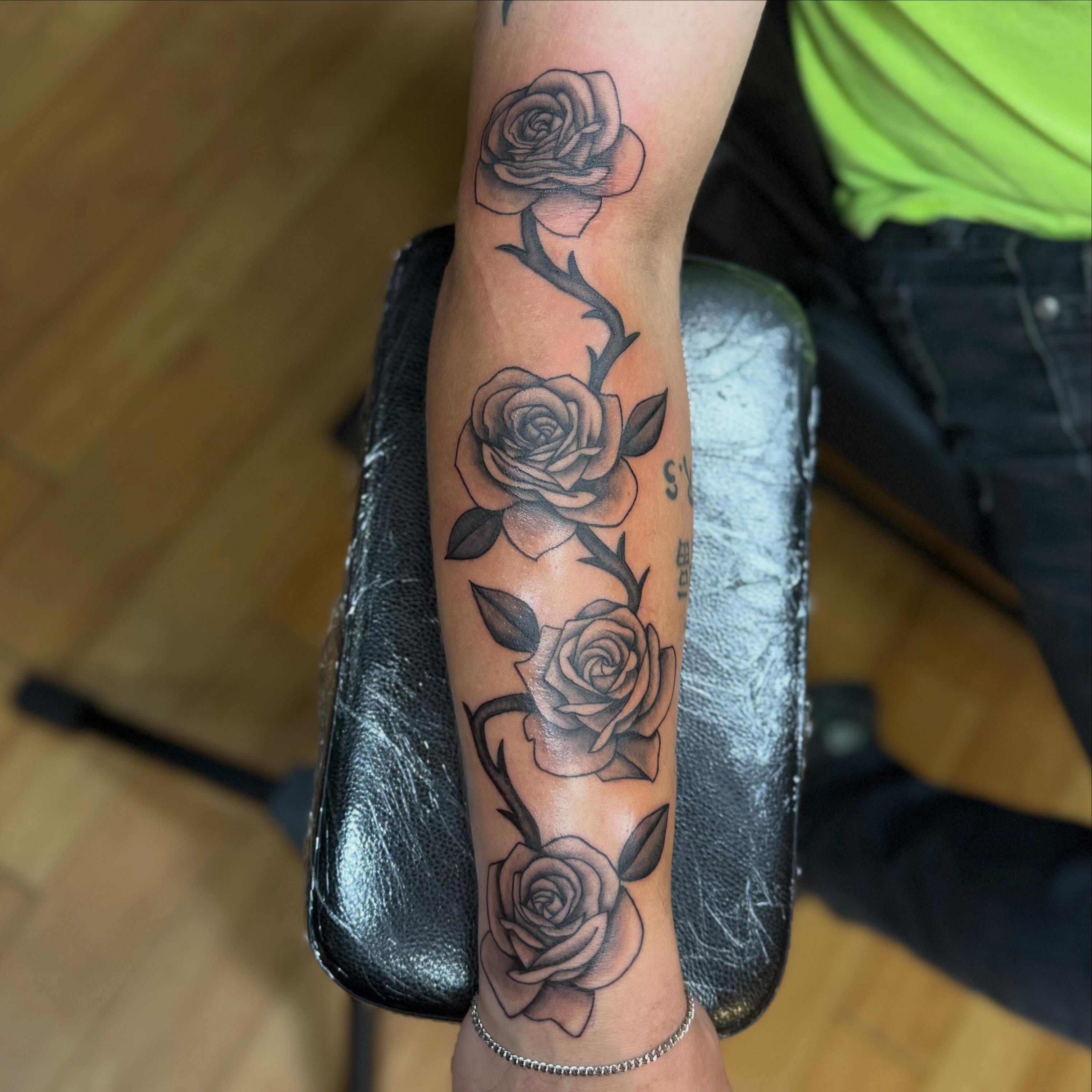 Roses black and grey tattoo on the forearm by Nic