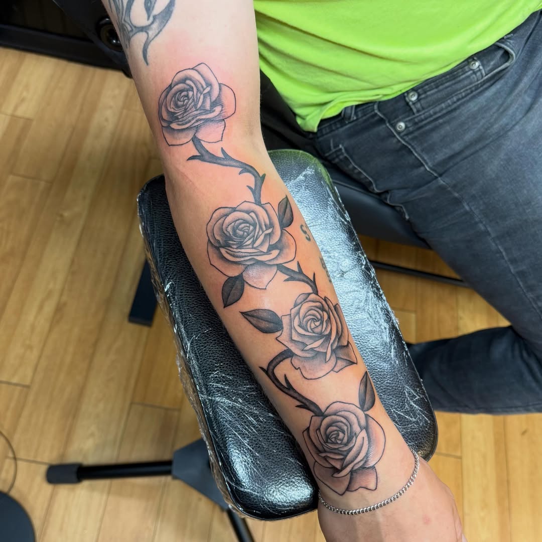 Roses black and grey tattoo on the forearm by Nic