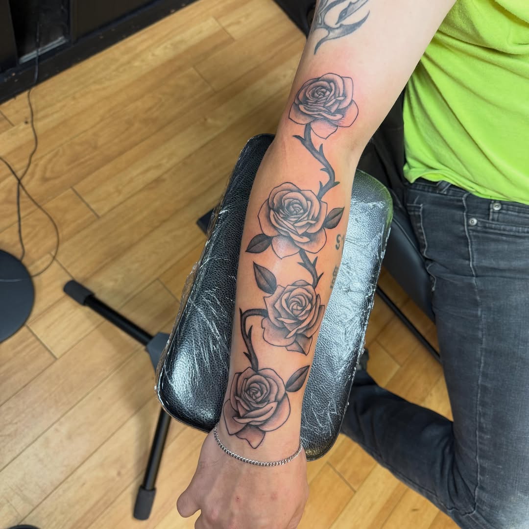 Roses black and grey tattoo on the forearm by Nic