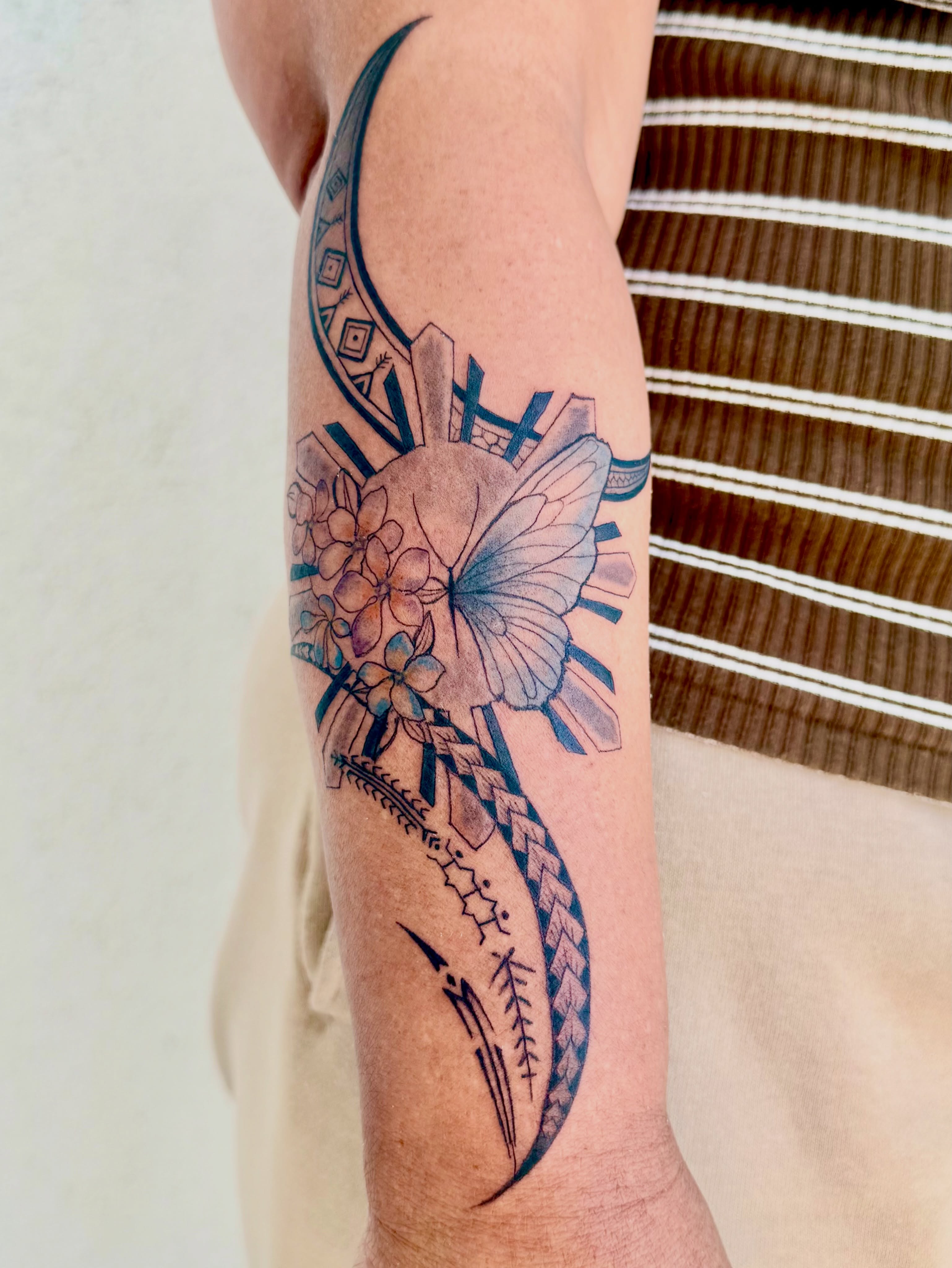 Butterfly and flowers geometric tattoo on the forearm by Healoha “Lindelle” Kamanu
