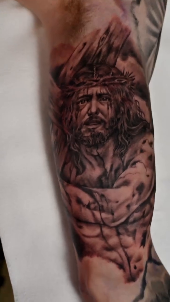 Jesus Christ portrait realism tattoo on the forearm by Michael ORegan