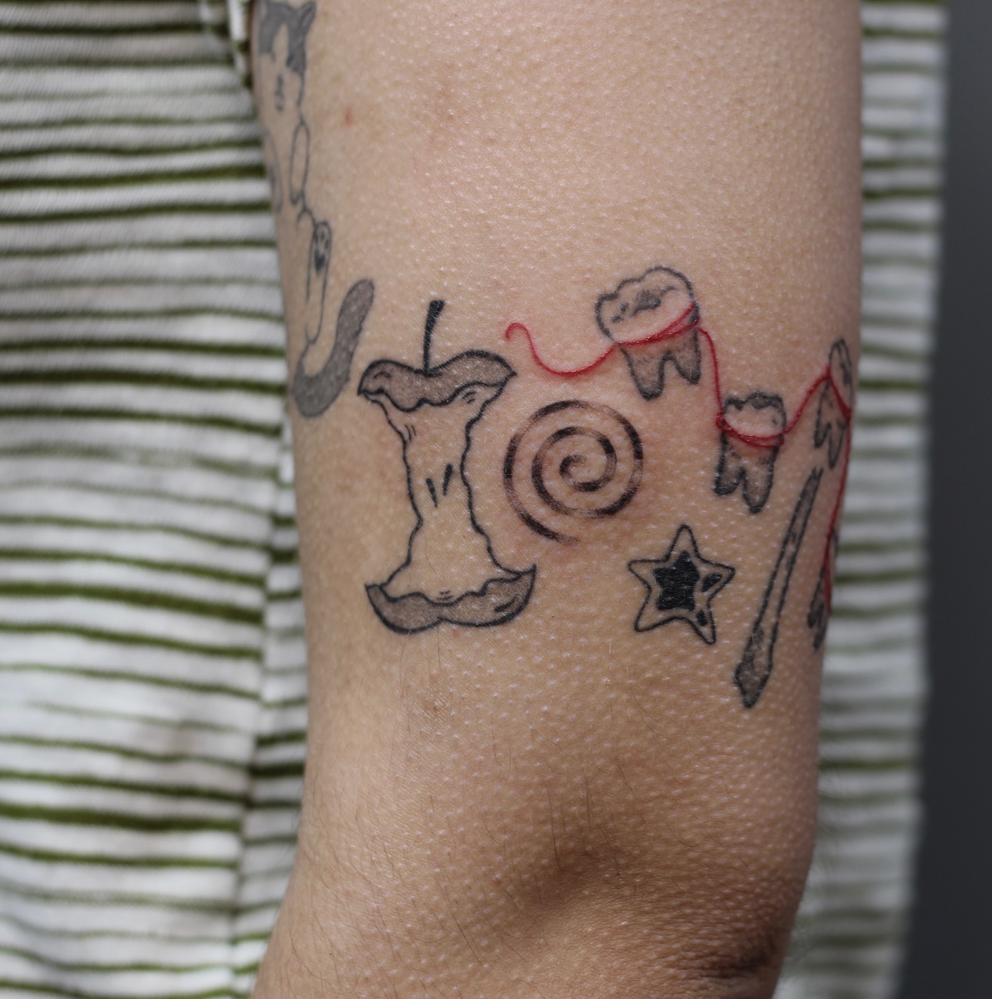 Candy-themed black and grey tattoo on the forearm by Amanda Karram