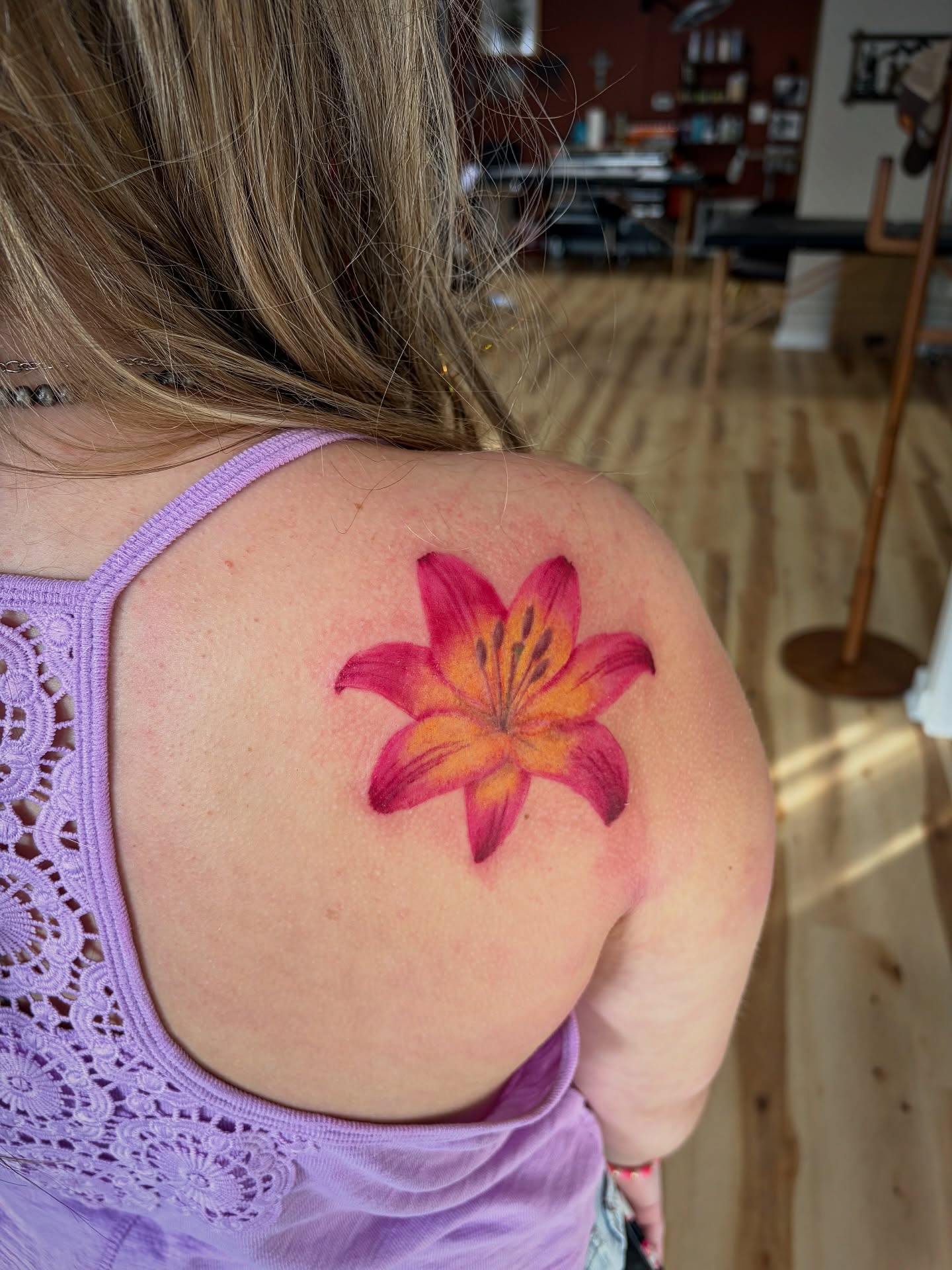 Lily realism tattoo on the shoulder by Francesca Siwa