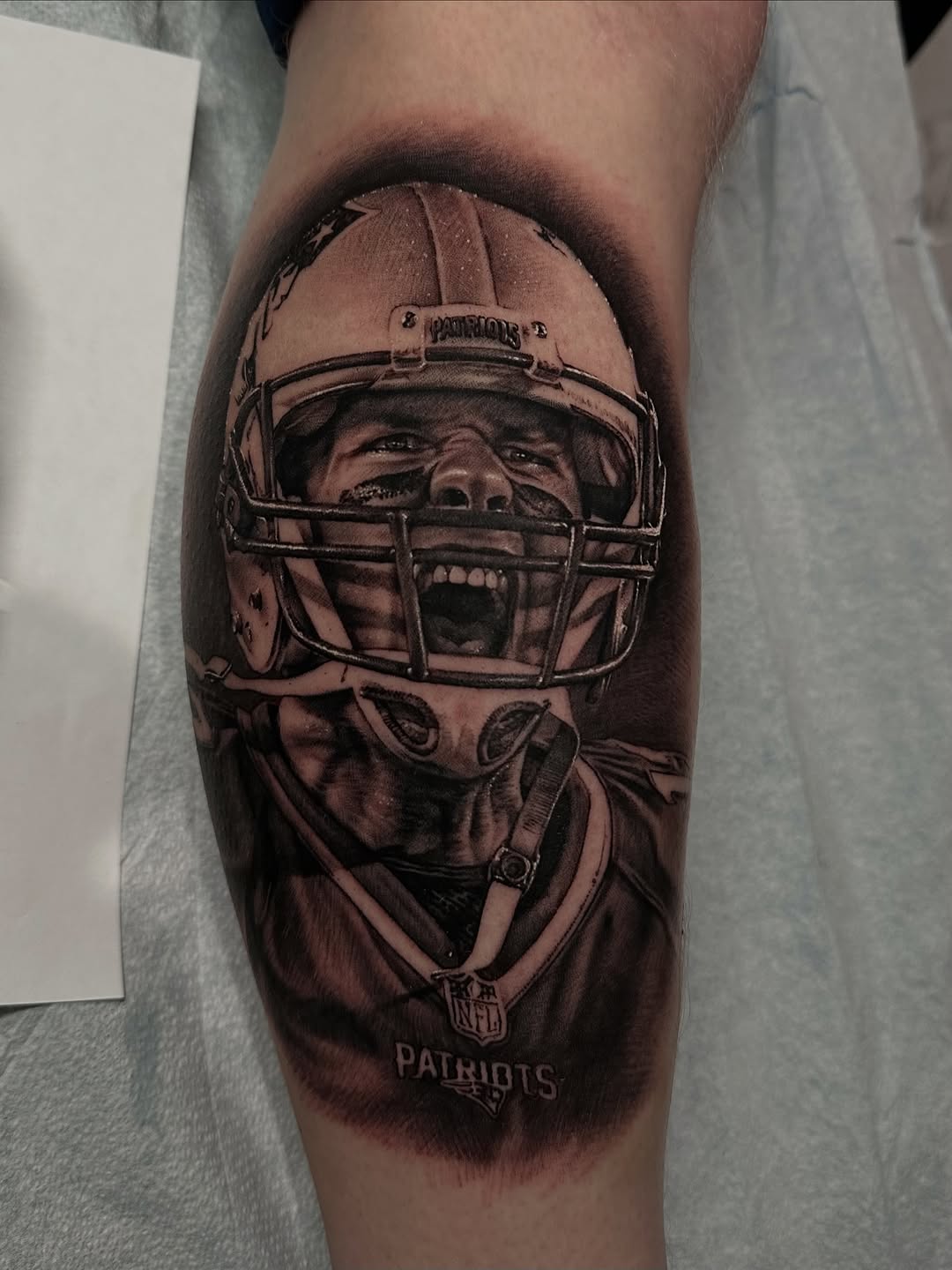 Football player in helmet realism tattoo on the forearm by Nico Perez