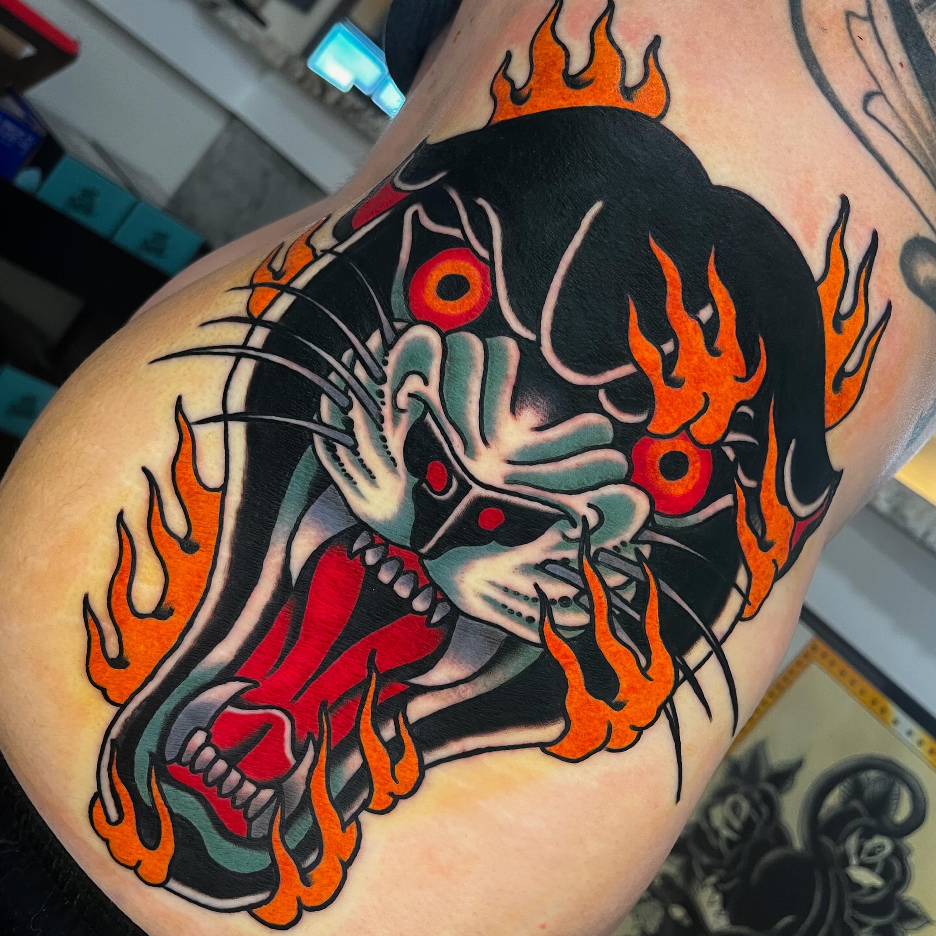 Skull with flames American traditional tattoo on the shoulder by Sky G, Colorado Springs, Colorado