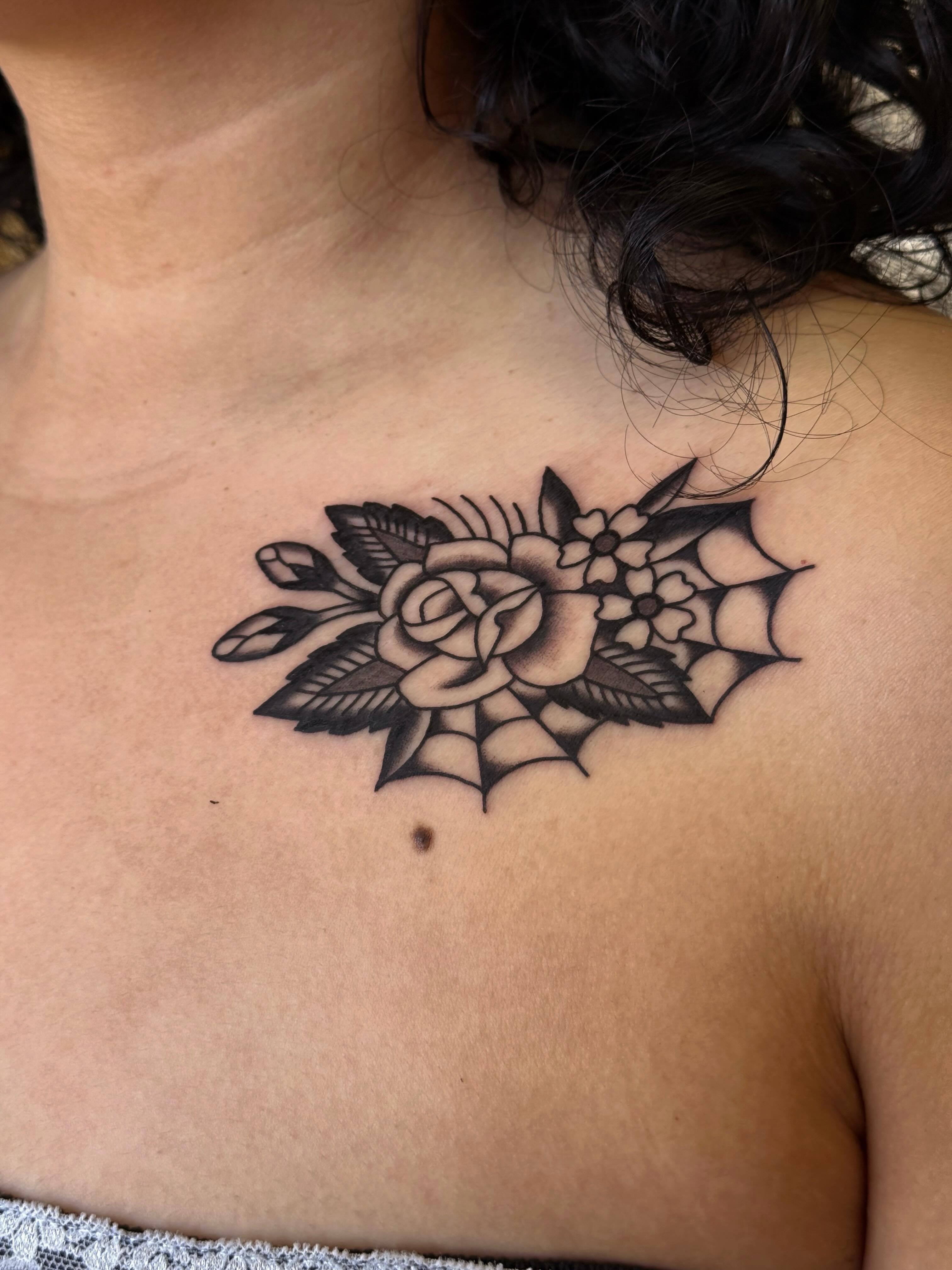 Floral bouquet black and grey tattoo on the chest by Bridgette Carberry