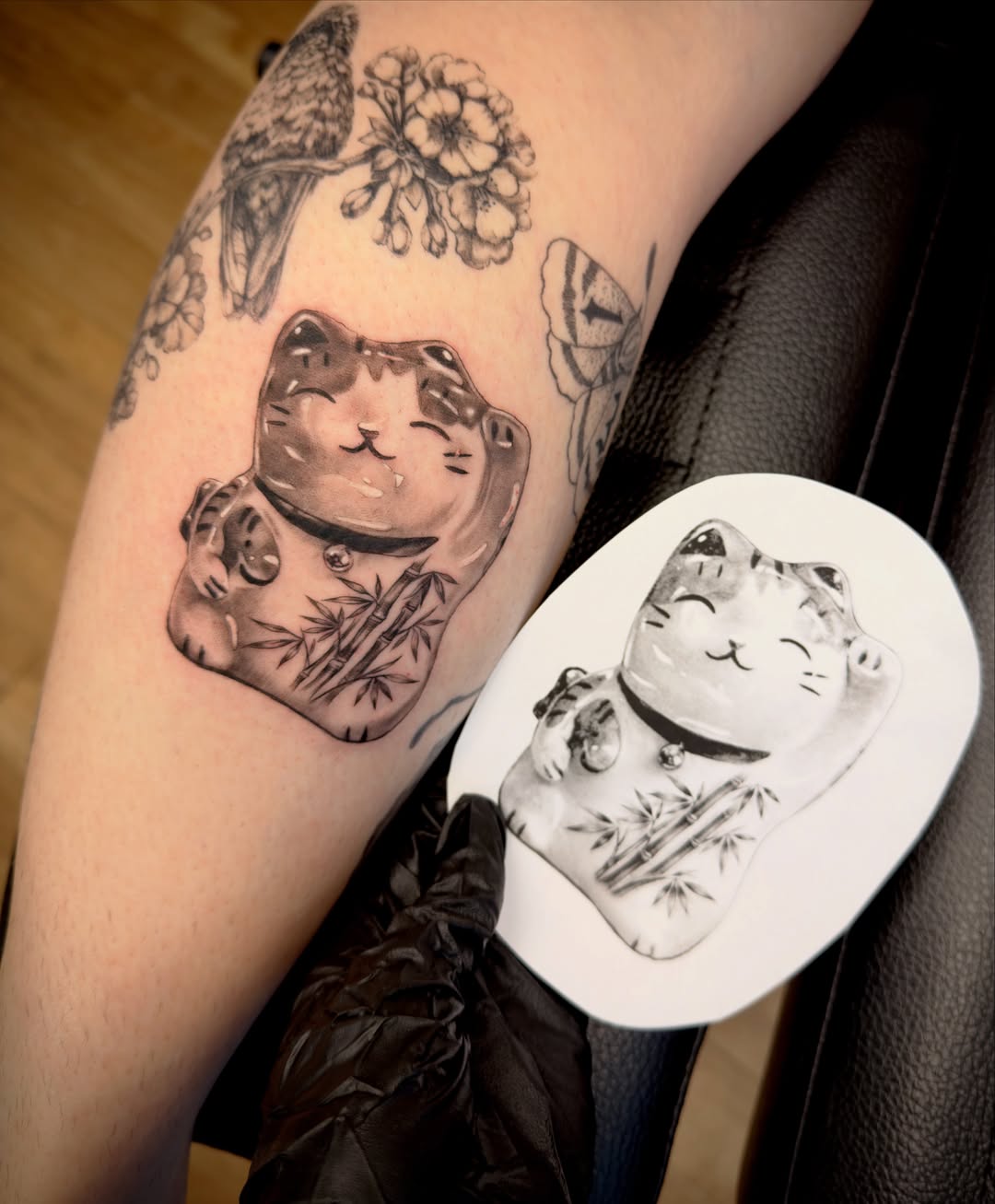 Cat black and grey tattoo on the forearm by Aristova Anastasia