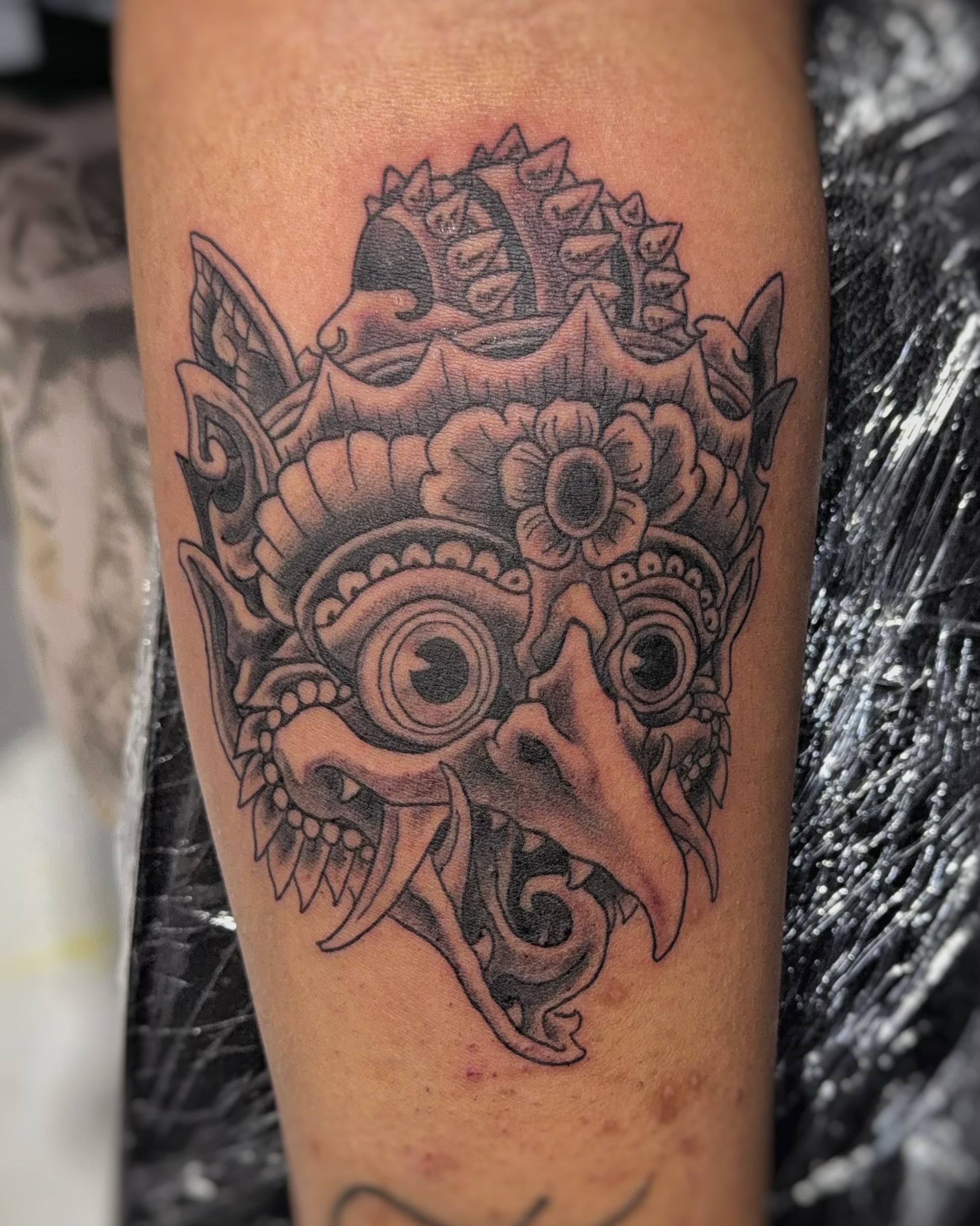 Mask black and grey tattoo on the forearm by James Bird, Vancouver, British Columbia
