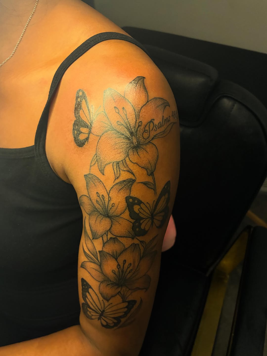 Lilies and butterflies with script fine line tattoo on the upper arm by ɪɪɴᴋᴇᴅʙʏʀᴇɴɴ🐉
