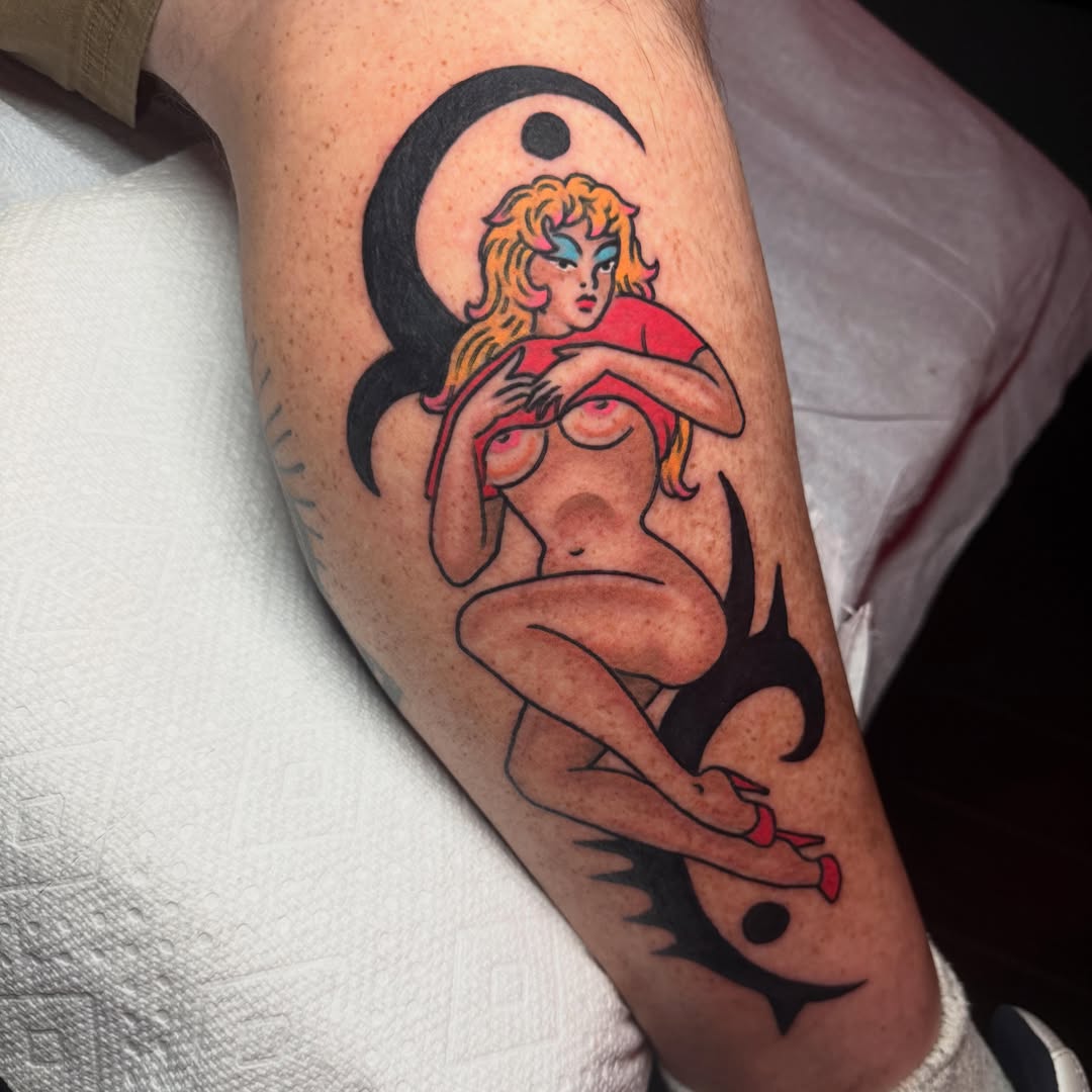 Woman on man American traditional tattoo on the forearm by Chris Bishop