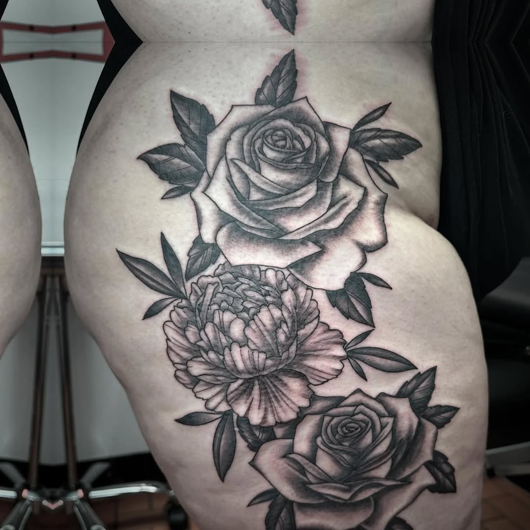 Roses and peony neo-traditional tattoo on the thigh by Jaleel Trantow
