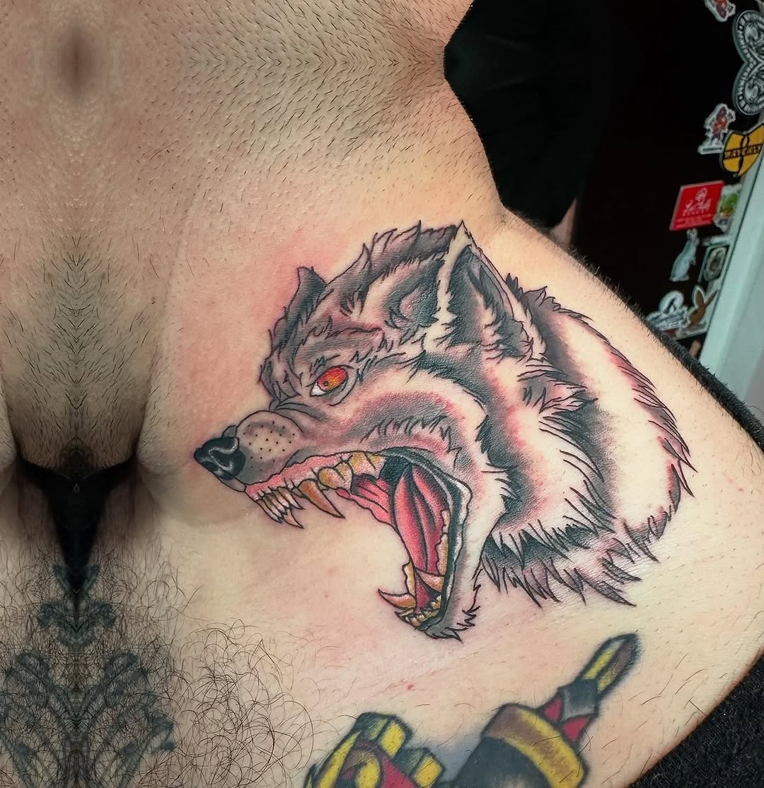 Wolf head realism tattoo on the chest by Jaleel Trantow