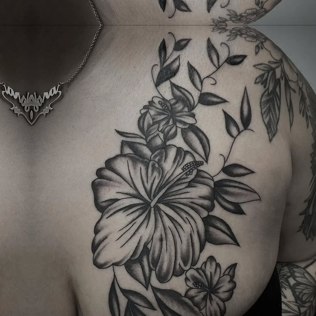 Hibiscus flowers and leaves fine line tattoo on the chest by Murl Dietrich