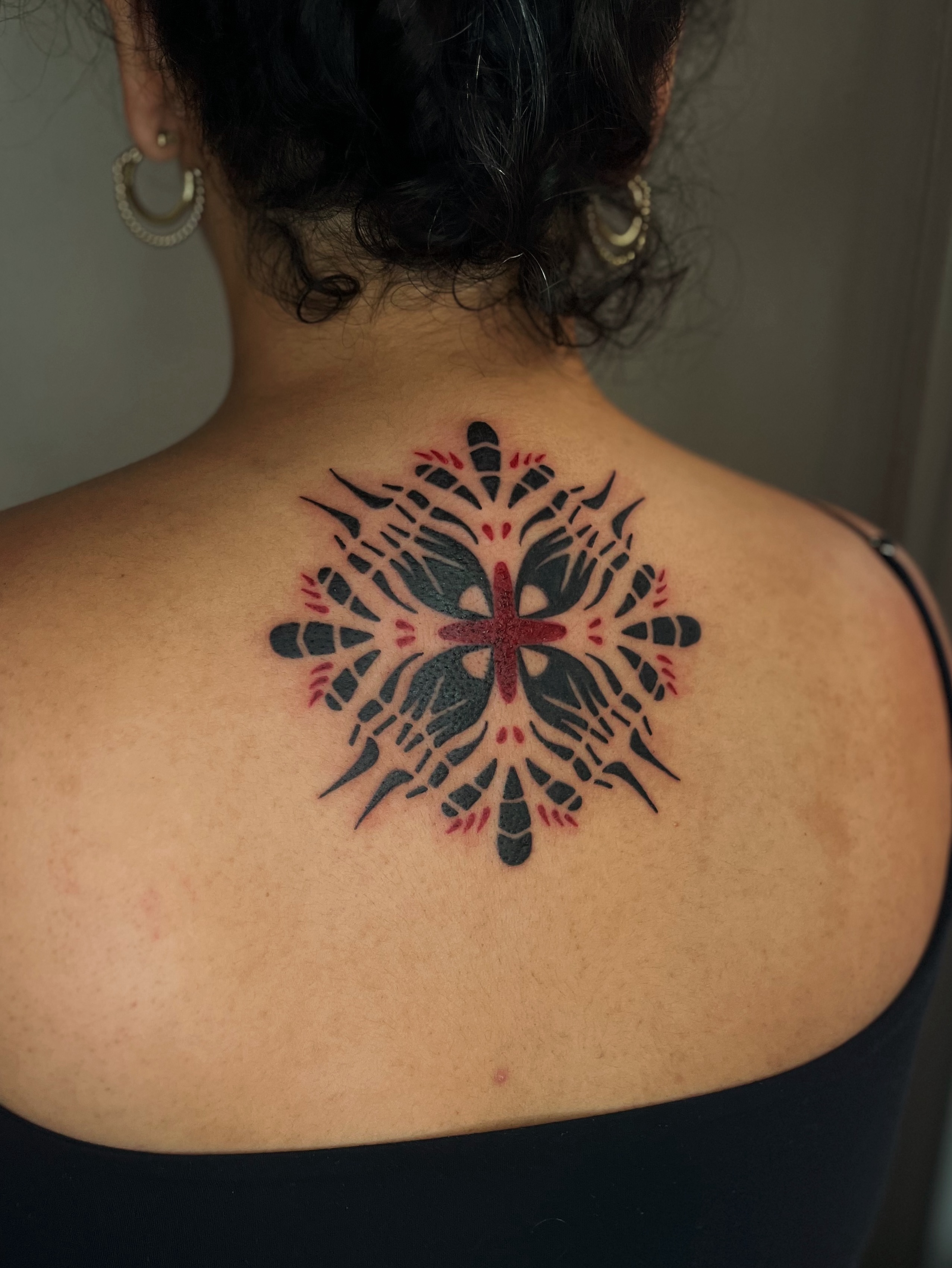 Cross with geometric patterns geometric tattoo on the back by Abigail, San Francisco, California