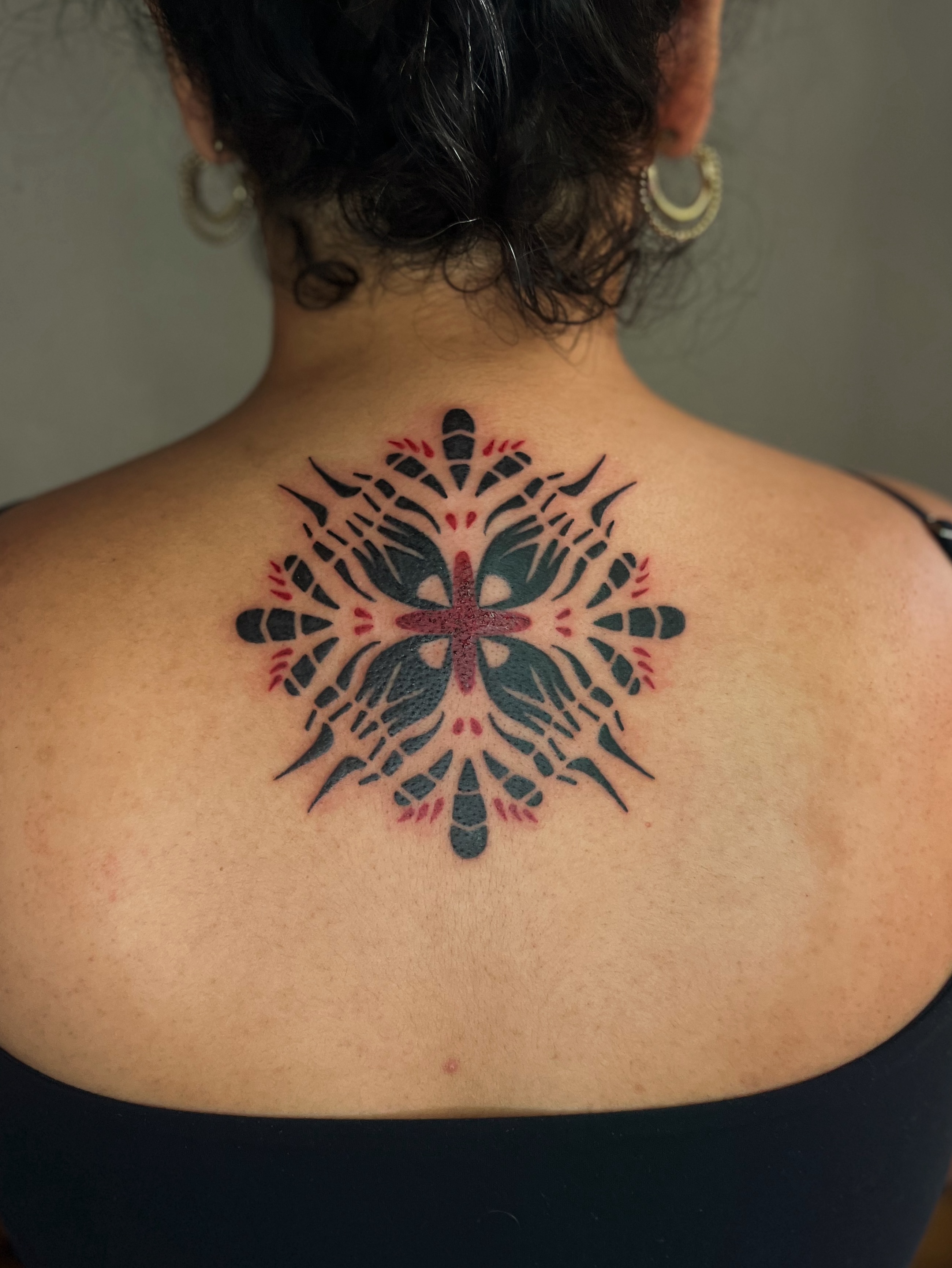 Geometric snowflake geometric tattoo on the back by Abigail, San Francisco, California