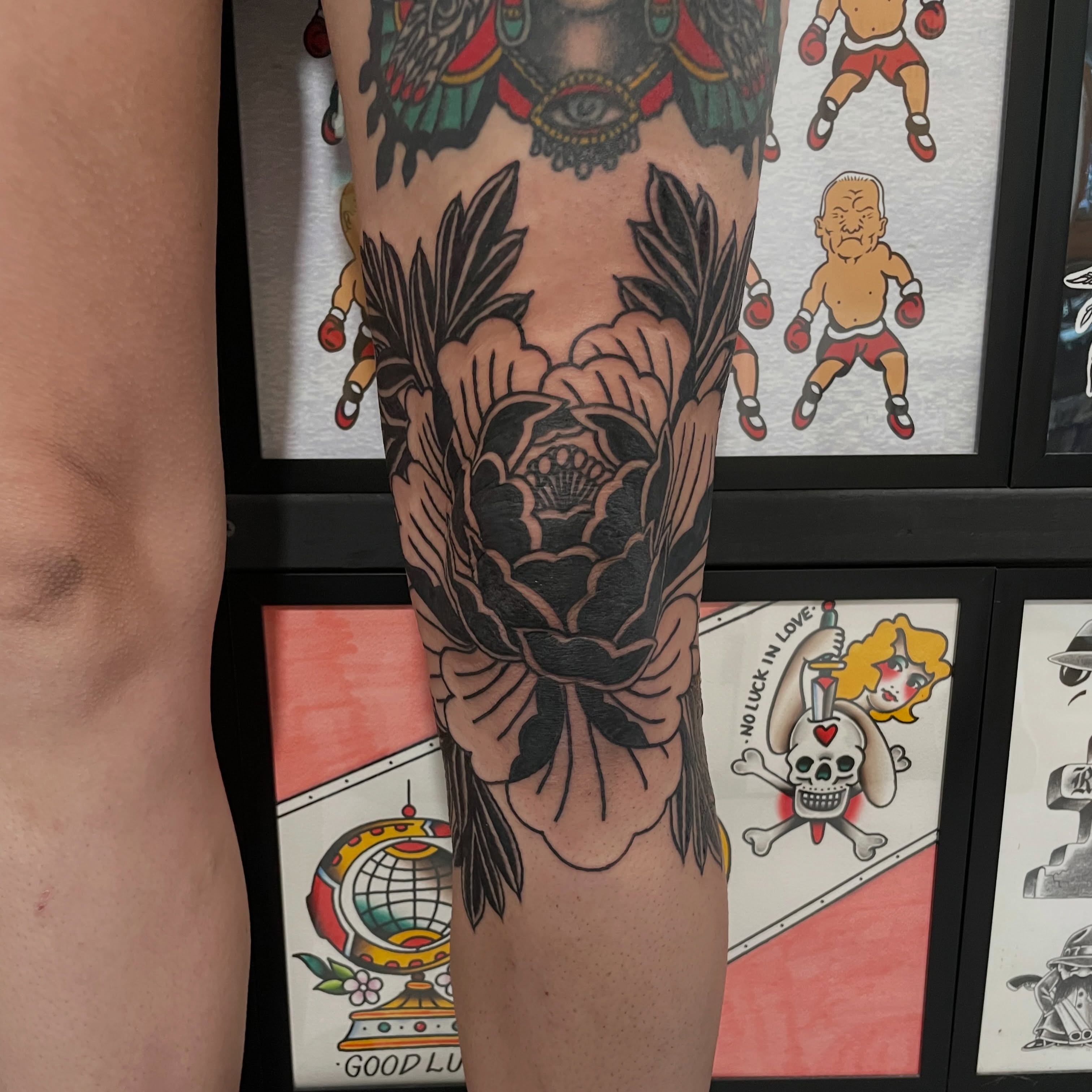 Peony American traditional tattoo on the calf by Greg De Hoot, Youngsville, North Carolina