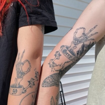 Skull and cup American traditional tattoo on the forearm by Joshua Scott