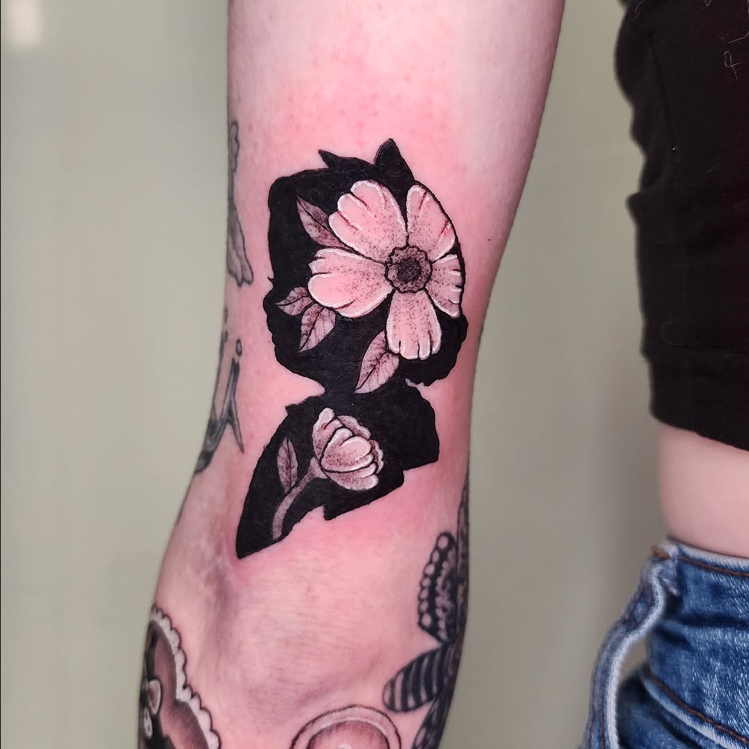 Flower silhouette black and grey tattoo on the forearm by Lindsey Andrew, Englewood, Colorado