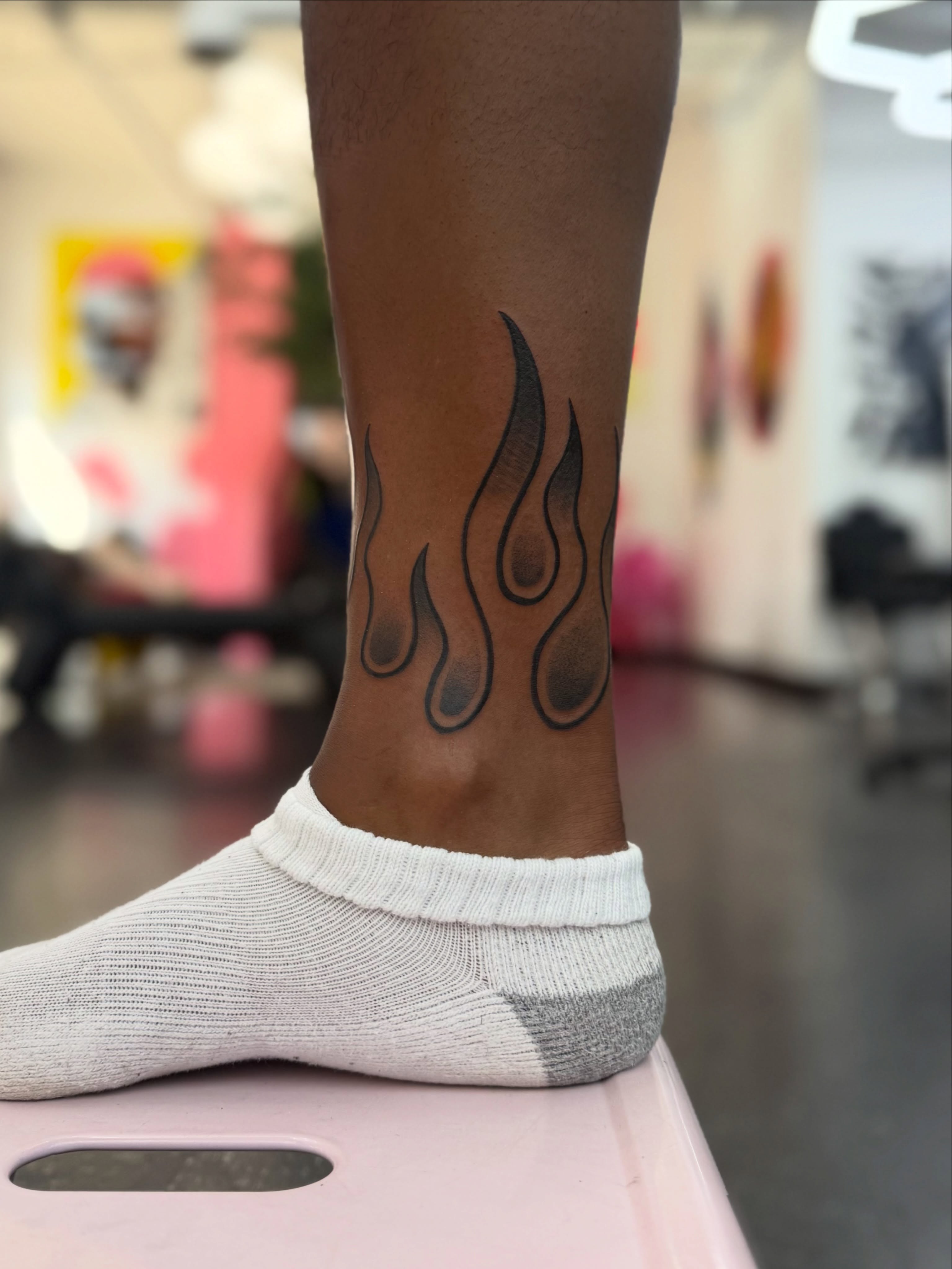 Flames black and grey tattoo on the calf by Joshua Carter