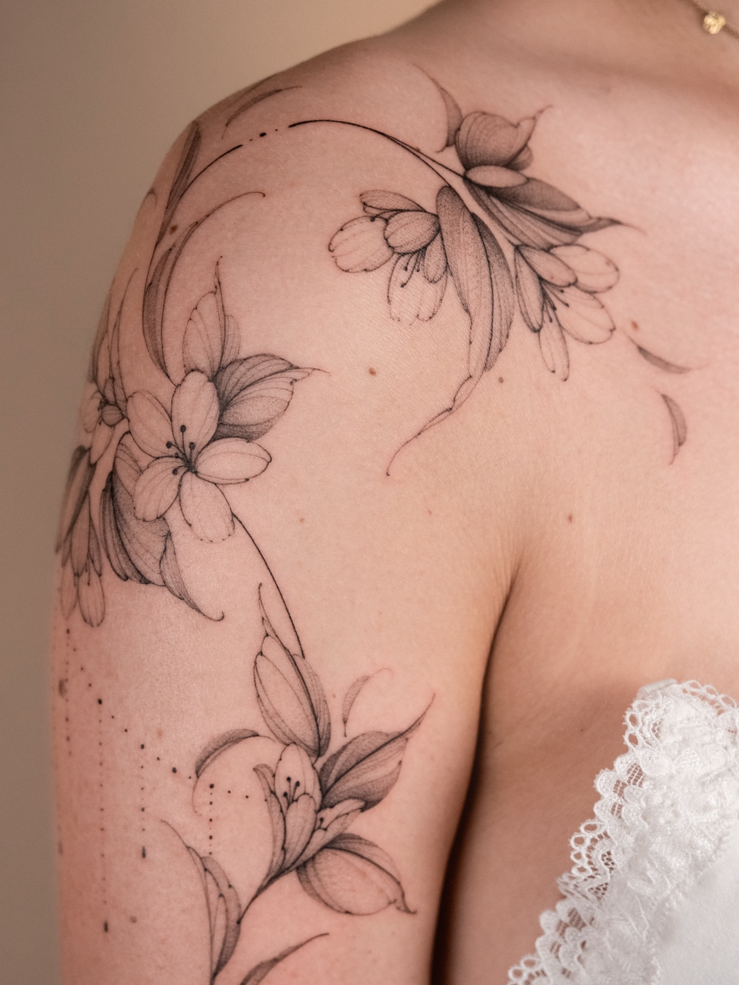 Floral arrangement black and grey tattoo on the shoulder by i flower you