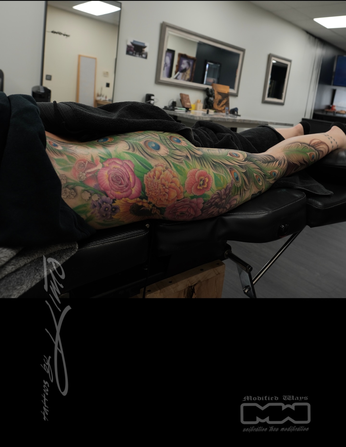Peacock feathers and floral bouquet new school tattoo on the leg by Kansas City tattoo artist