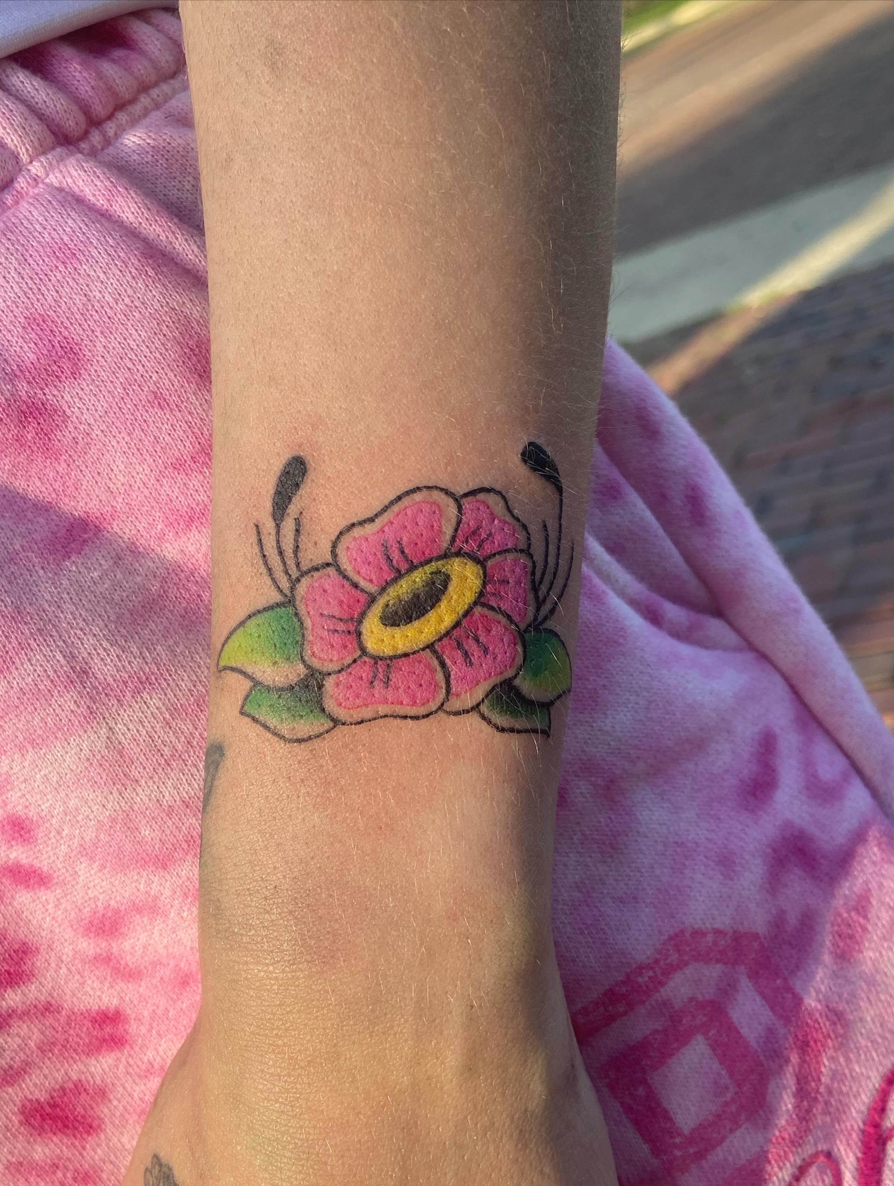Flower American traditional tattoo on the forearm by 🐆Cam Feral Tattoos