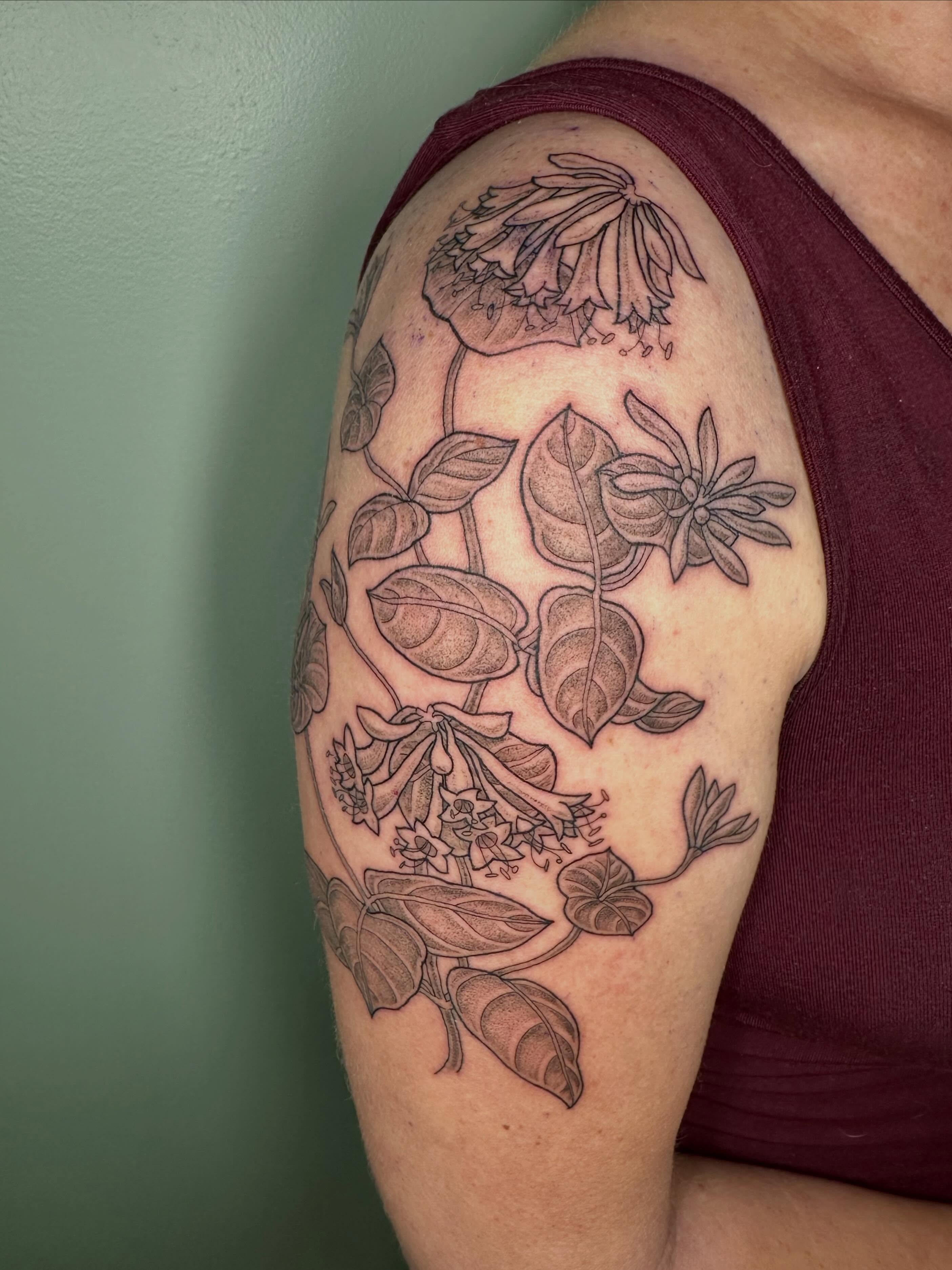 Botanical arrangement black and grey tattoo on the shoulder by Sarah Roach