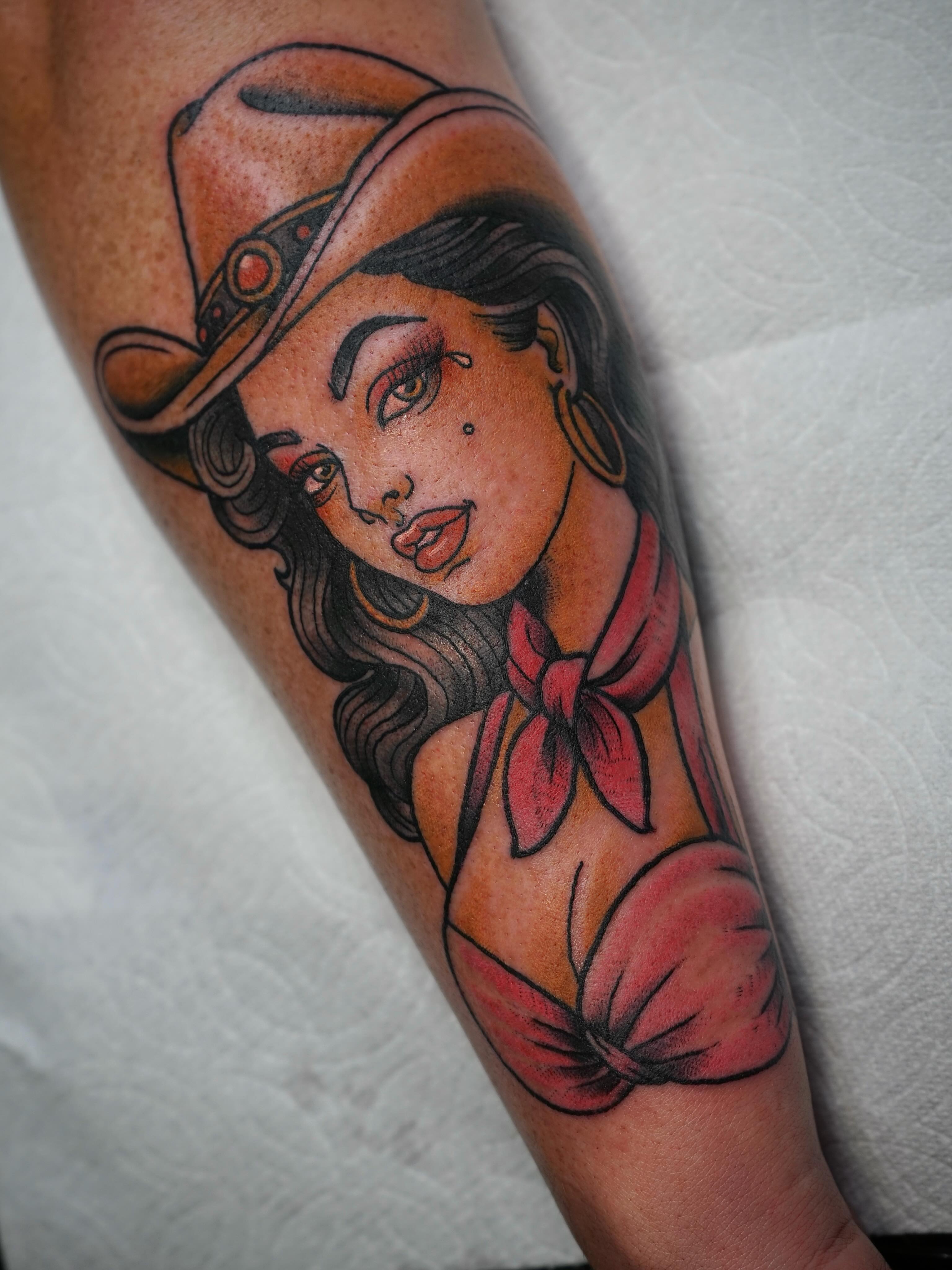 Woman wearing a hat American traditional tattoo on the forearm by Tyler Harrington