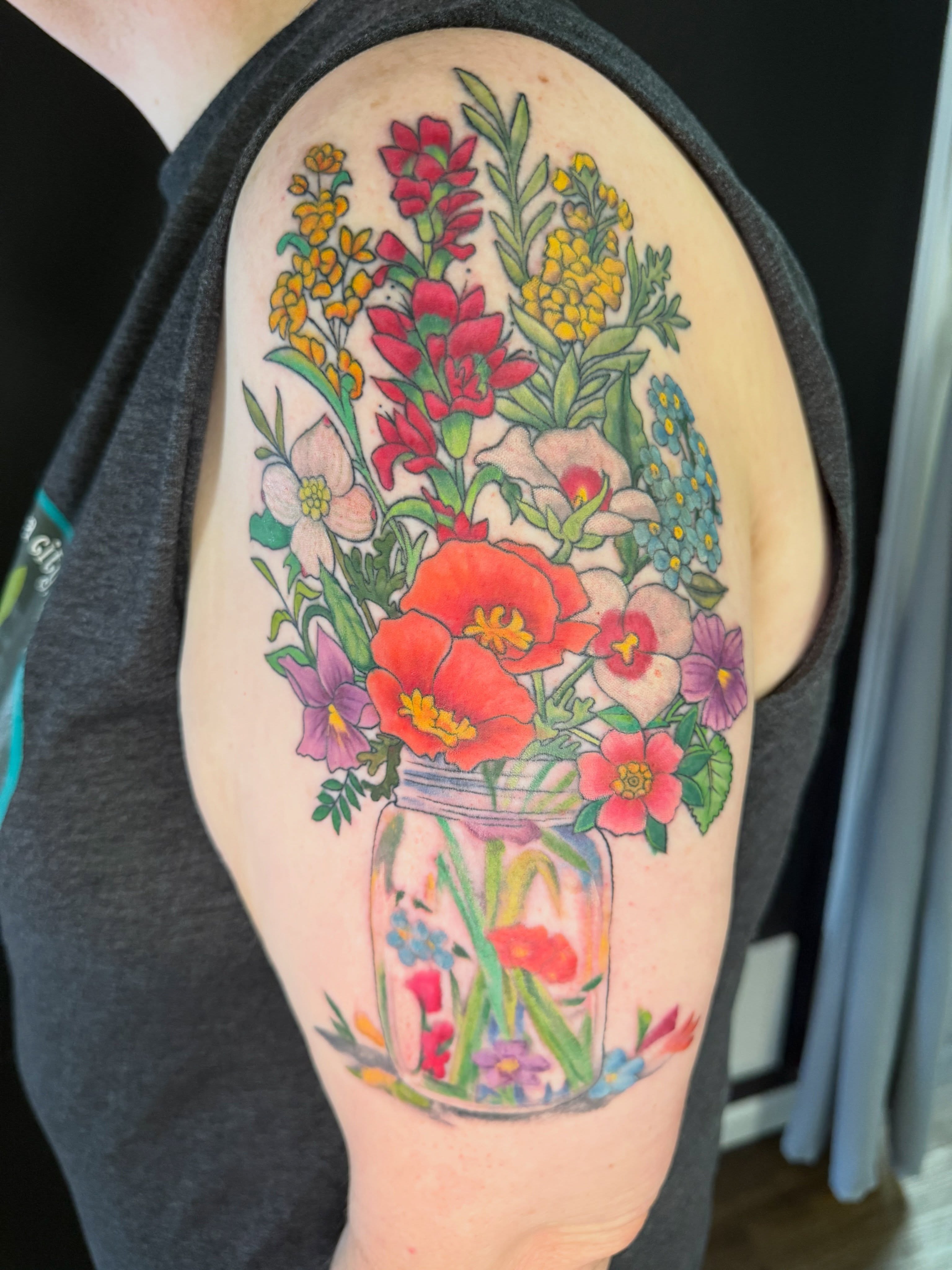 Flower bouquet new school tattoo on the upper arm by Michelle Balhan