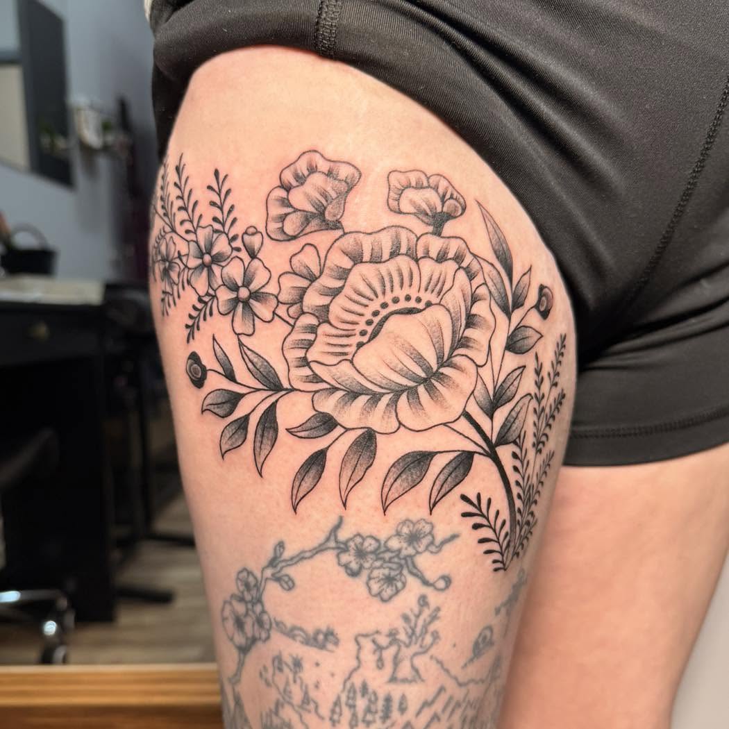 Floral arrangement black and grey tattoo on the thigh by Destiny A