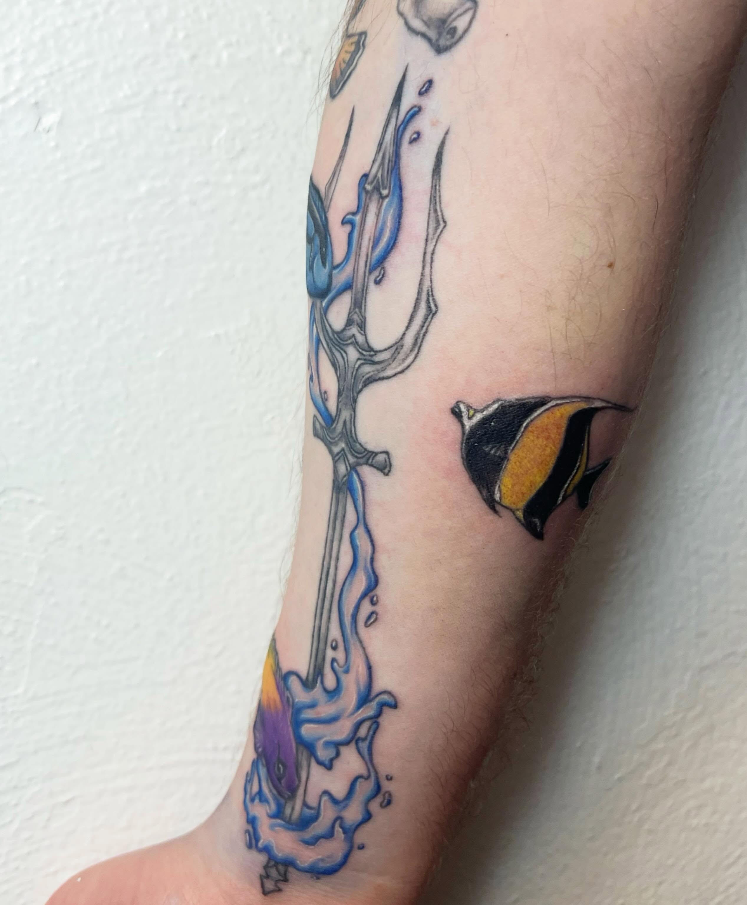 Trident and fish new school tattoo on the forearm by Amber Rose