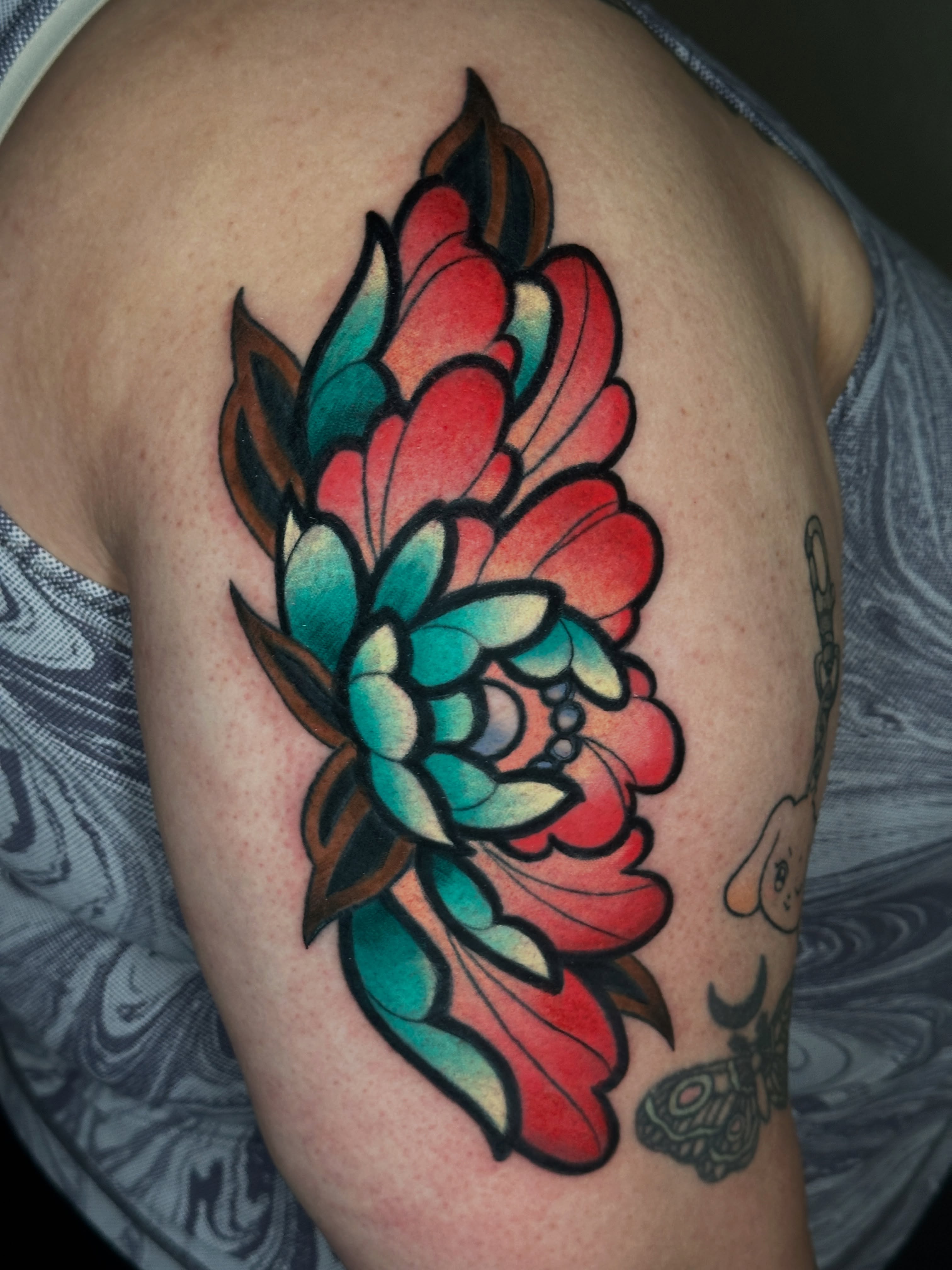 Floral bouquet American traditional tattoo on the shoulder by Dustin Hughes