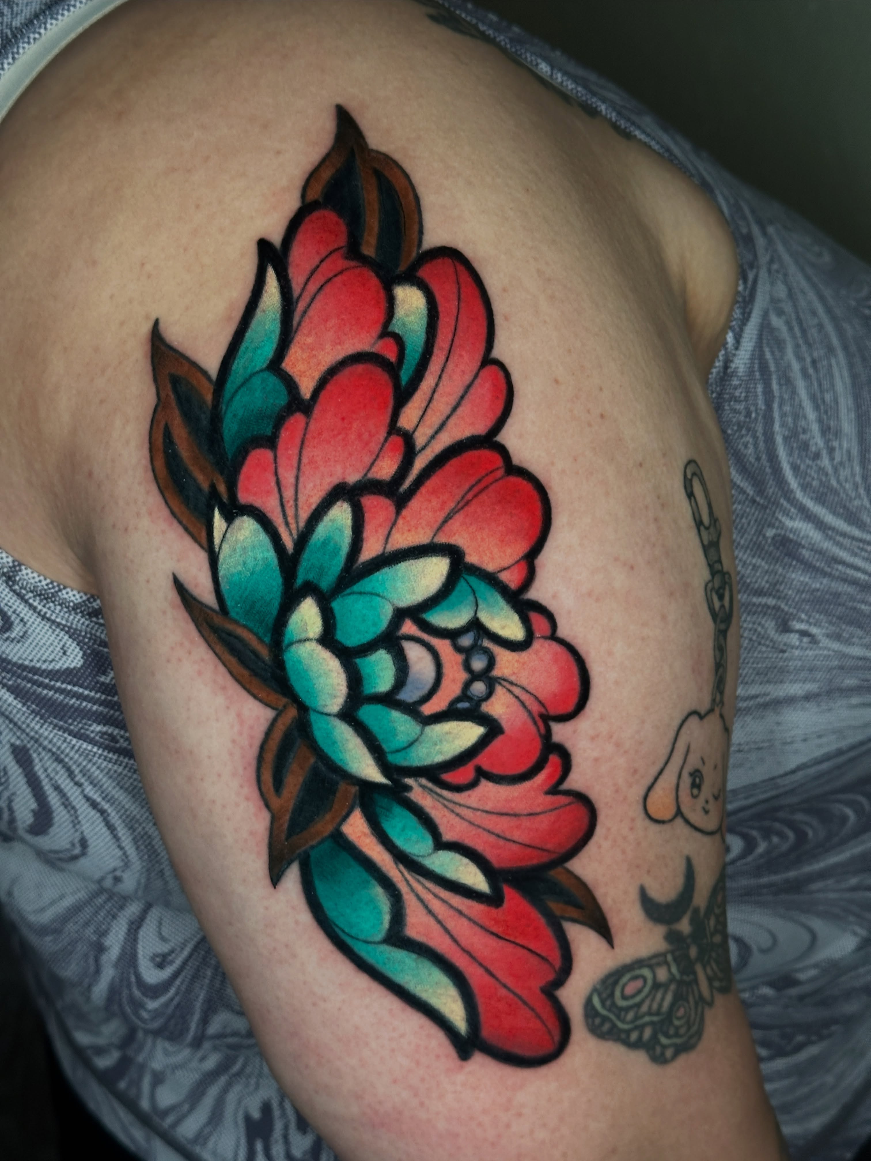 Floral arrangement American traditional tattoo on the shoulder by Dustin Hughes