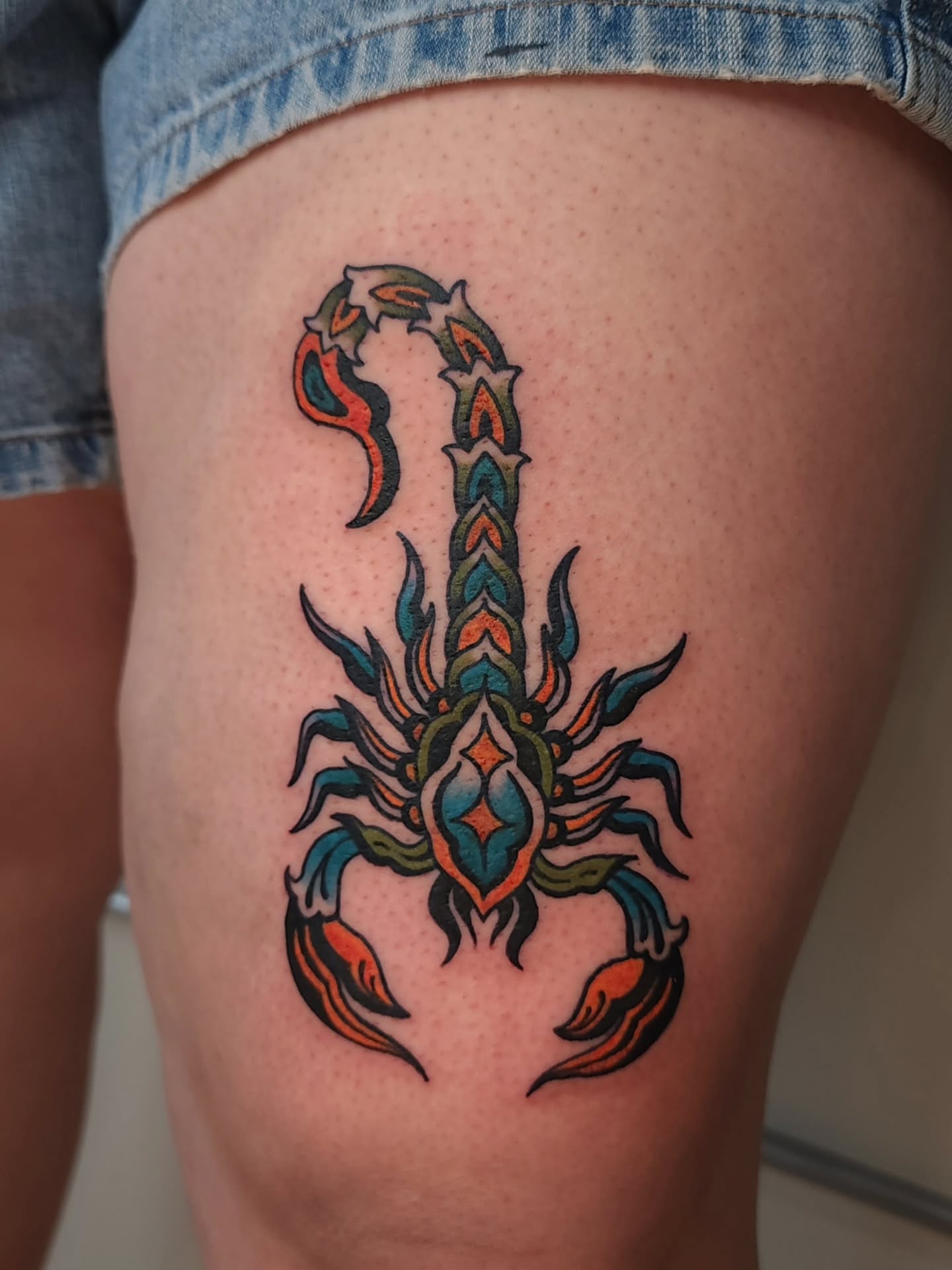 Scorpion geometric tattoo on the thigh by Maxine Stewart